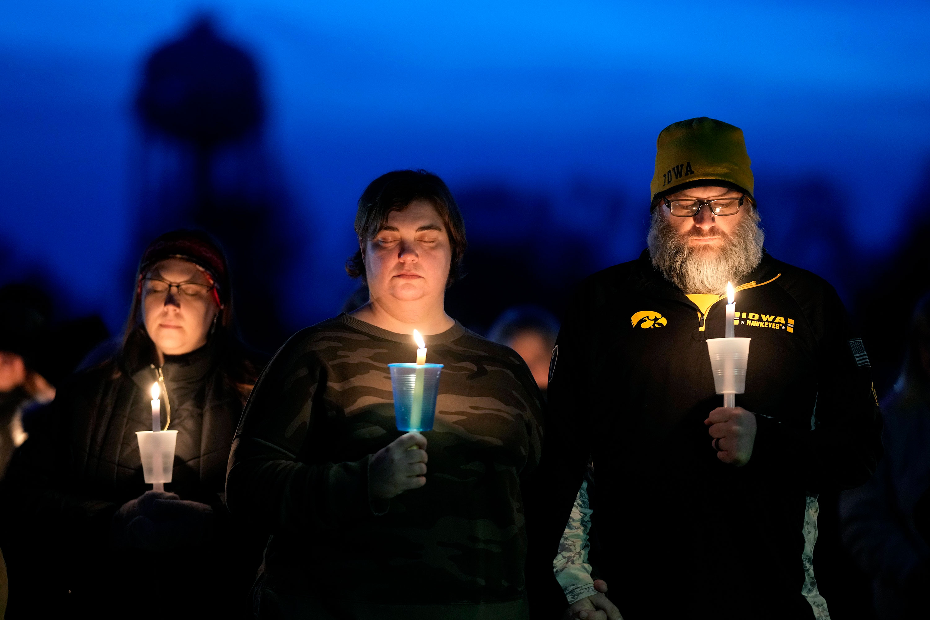Local residents pray during a candlelight vigil following a shooting at Perry High School on January 4 in Perry, Iowa. 