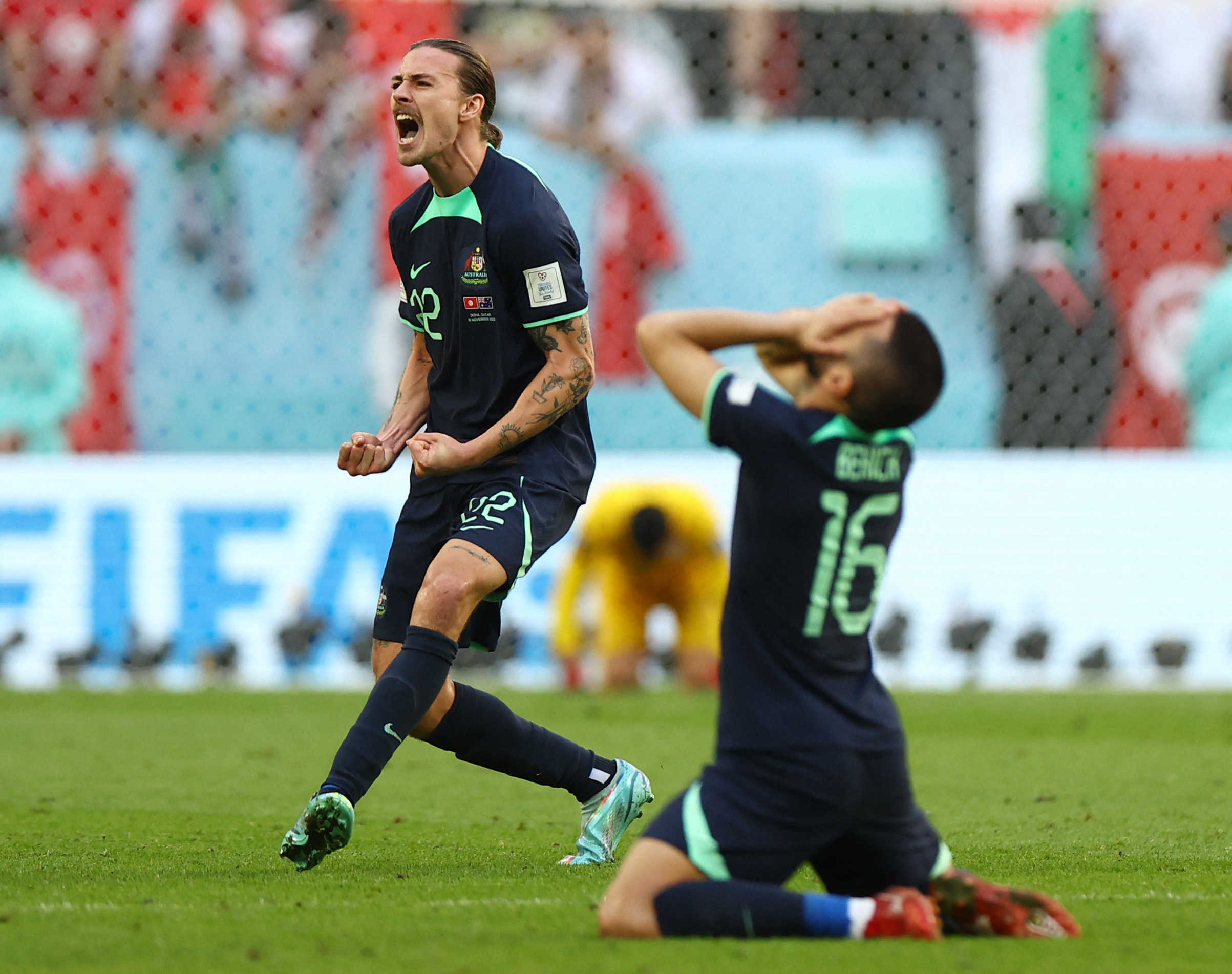 Australia's Jackson Irvine and Aziz Behich celebrate after the match against Tunisia on Saturday, November 26. 