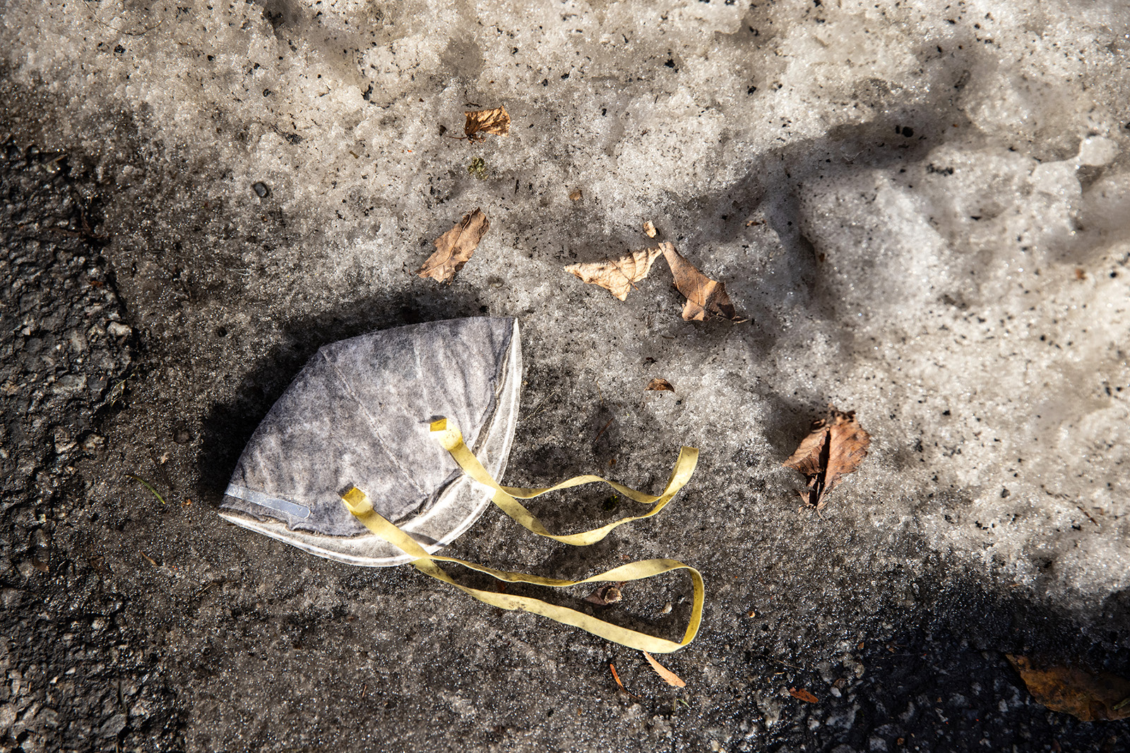 A mask lies in the snow outside an apartment building on December 23, 2020 in White Plains, New York.
