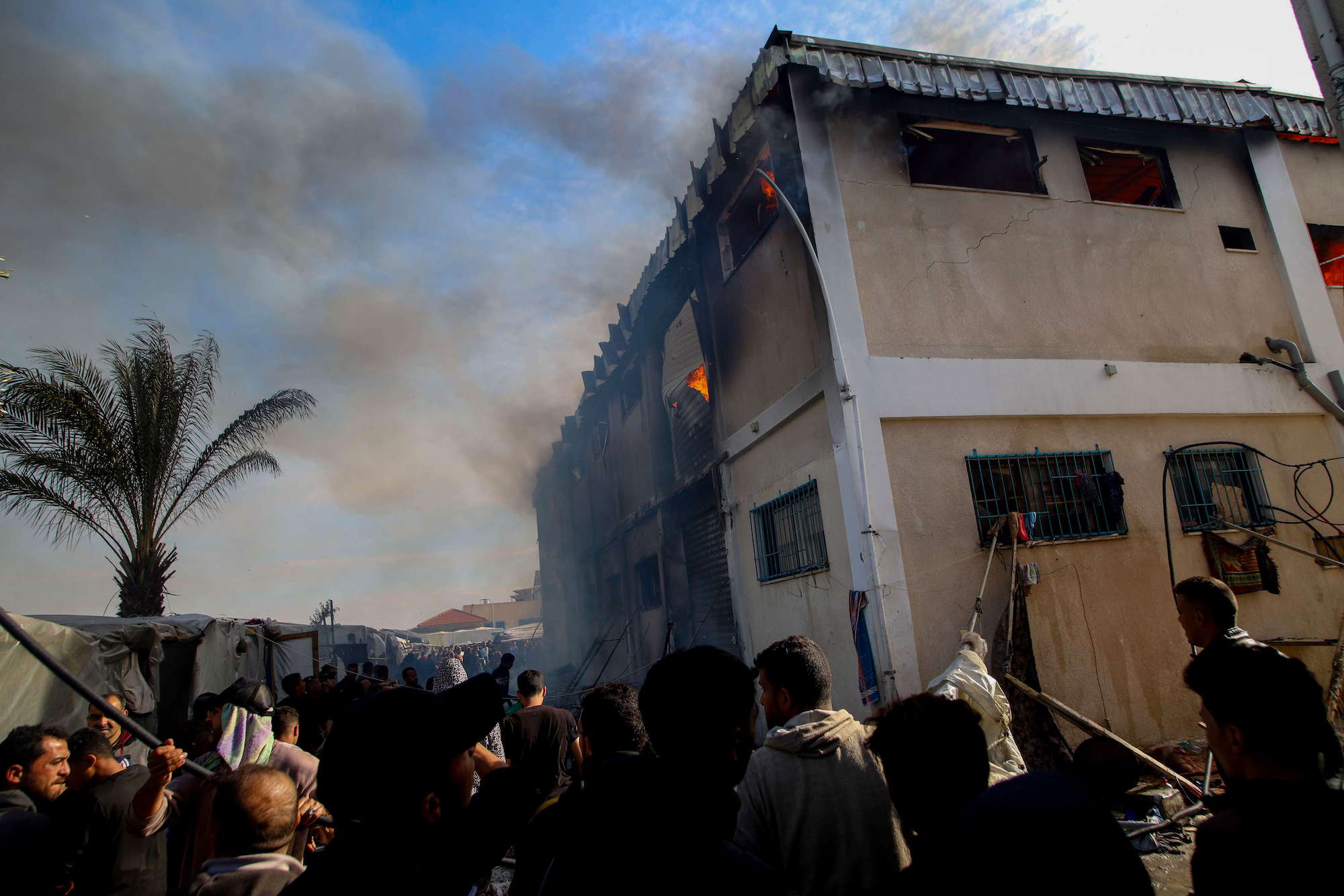Smoke and fire is seen after a strike on a UNRWA facility in Khan Younis, Gaza, on Wednesday.