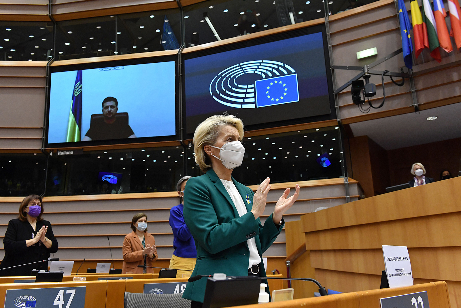 European Commission President Ursula von der Leyen, center, applauds as Ukrainian President Volodymyr Zelensky (on screen) delivers a speech at the EU headquarters in Brussels, on March 1. 