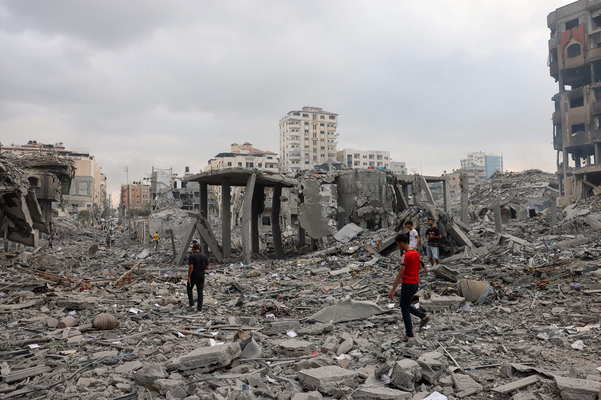 Palestinians inspect the destruction from Israeli airstrikes in Gaza City's al-Rimal neighbourhood early on October 10.