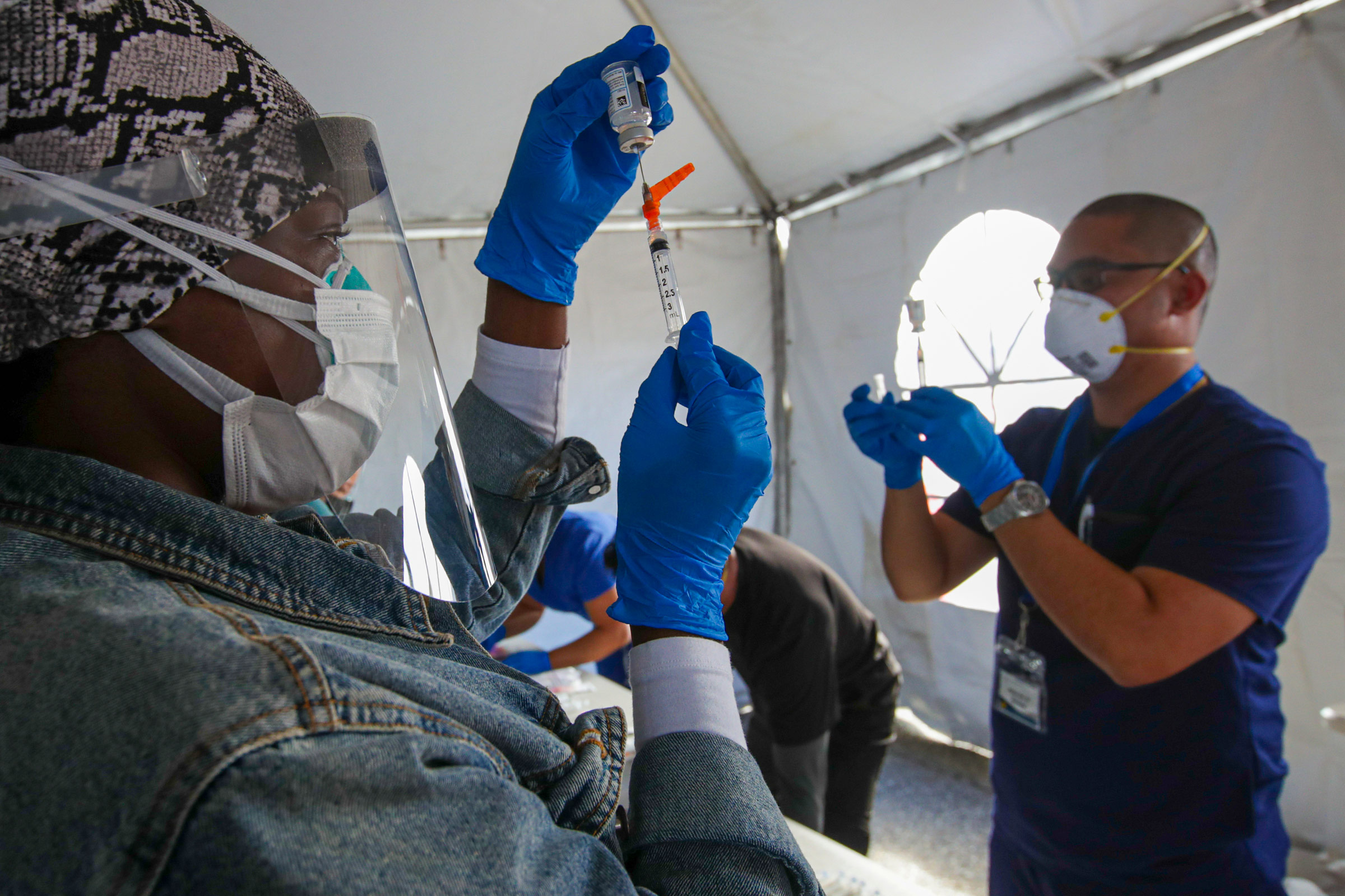 Mahaliah Catie, left, and Nathan Diwa prepare doses of the Moderna vaccine at a Covid-19 vaccination event in Fontana, California, on February 2. 