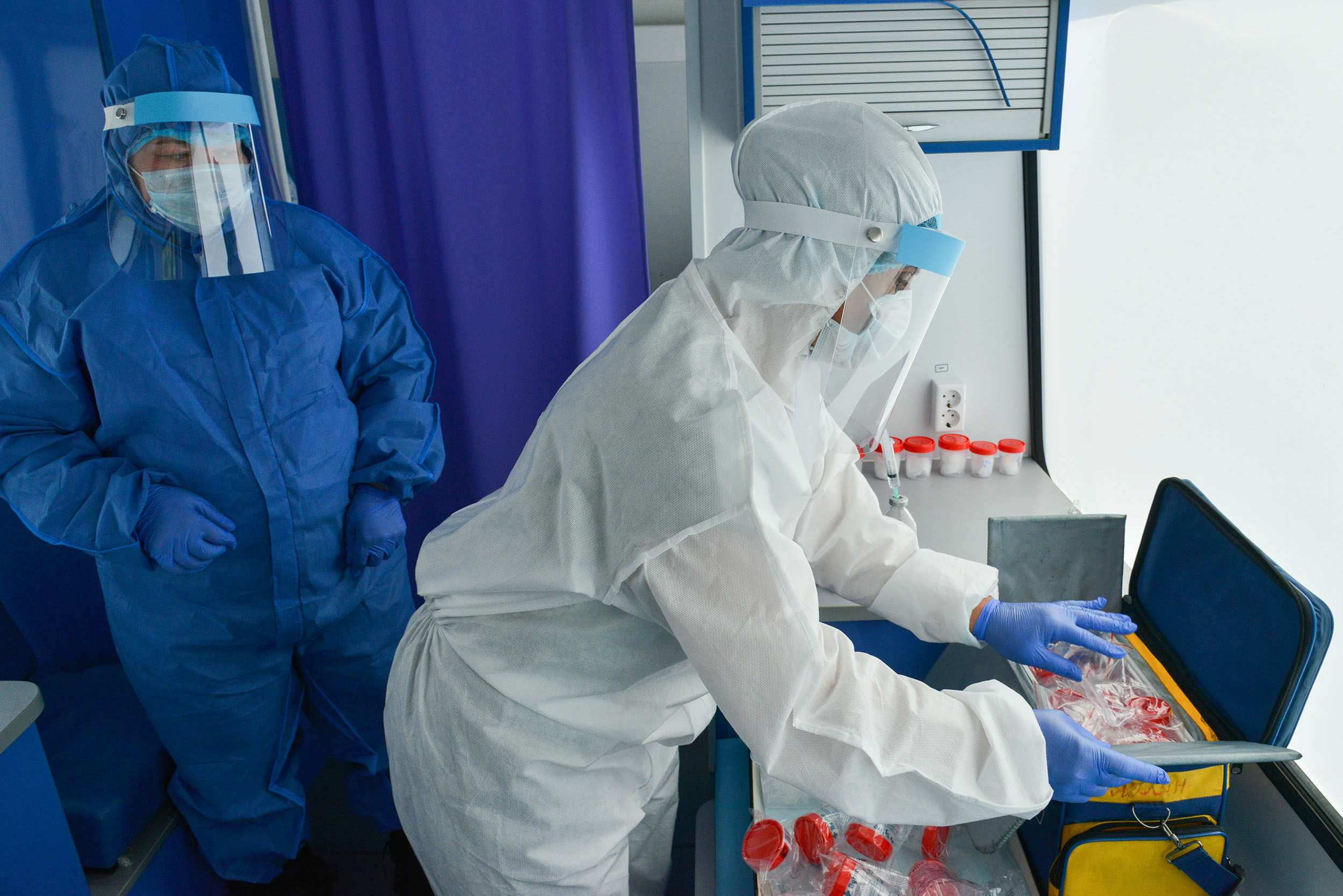 Medical workers collect samples in a mobile COVID-19 testing unit in Adygea, Russia, on Wednesday, May 13. 