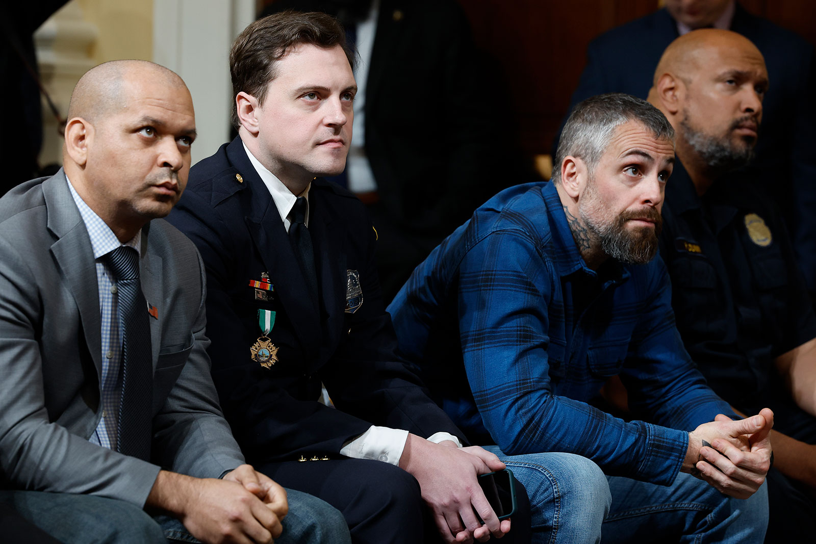 From left to right, former US Capitol Police Sergeant Aquilino Gonell, Metropolitan Police Officer Daniel Hodges, former Metropolitan Police Officer Michael Fanone and USCP Officer Harry Dunn listen to the final public session of the House select committee. 