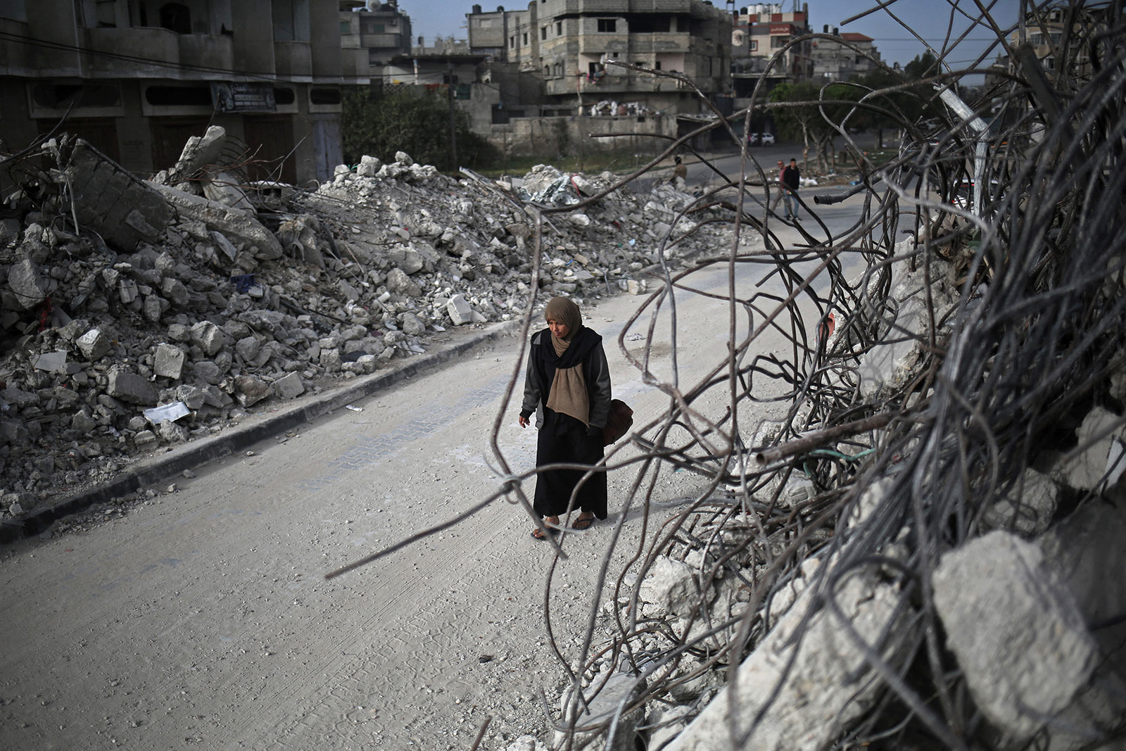 A woman walks past the rubble of houses destroyed by Israeli bombardment in Rafah, Gaza, on March 3.