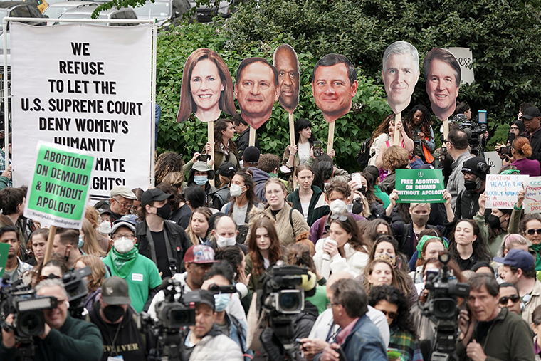 Pro-abortion demonstrators hold up photographs of U.S. Supreme Court Associate Justice Amy Coney Barrett, Associate Justice Samuel Alito, Associate Justice Clarence Thomas, Associate Justice Brett Kavanaugh and Chief Justice John Roberts during a protest in Foley Square.