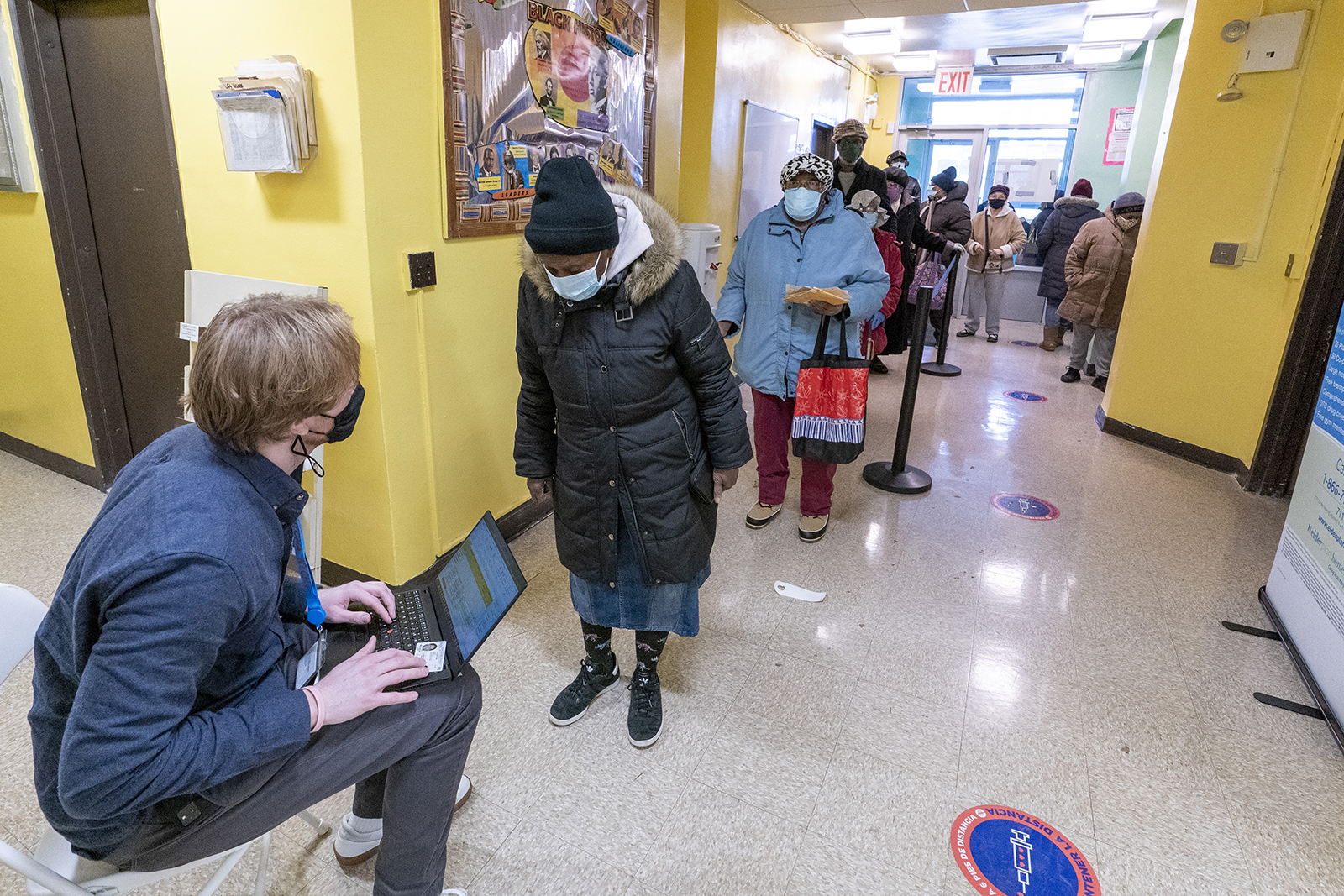 A screener registers residents of the William Reid Apartments at a Covid-19 pop-up vaccination site at the NYCHA housing complex on Saturday, January 23, in Brooklyn, New York.