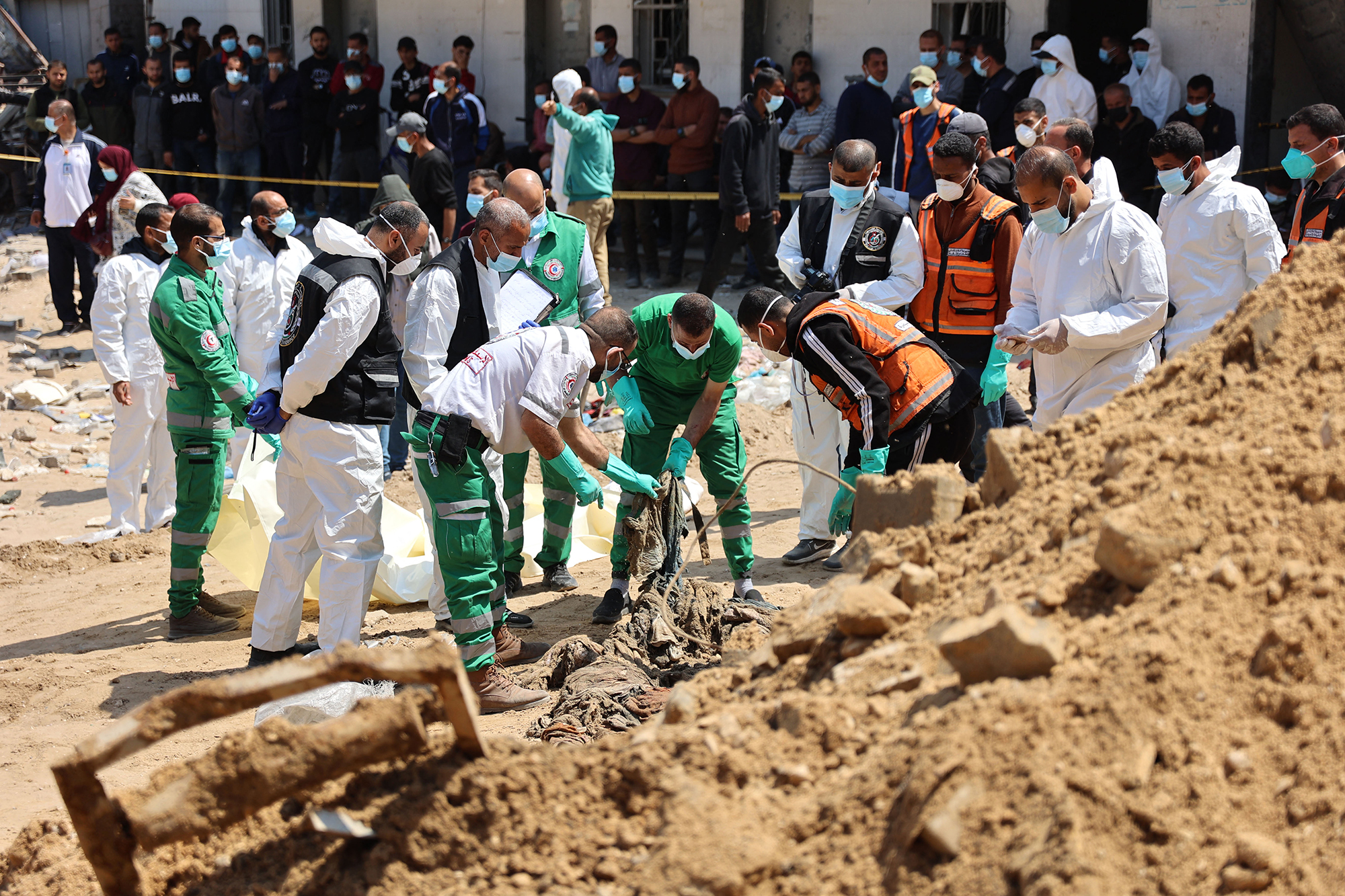 Palestinian forensic and civil defence recover human remains at the grounds of Al-Shifa hospital, Gaza, on April 8.