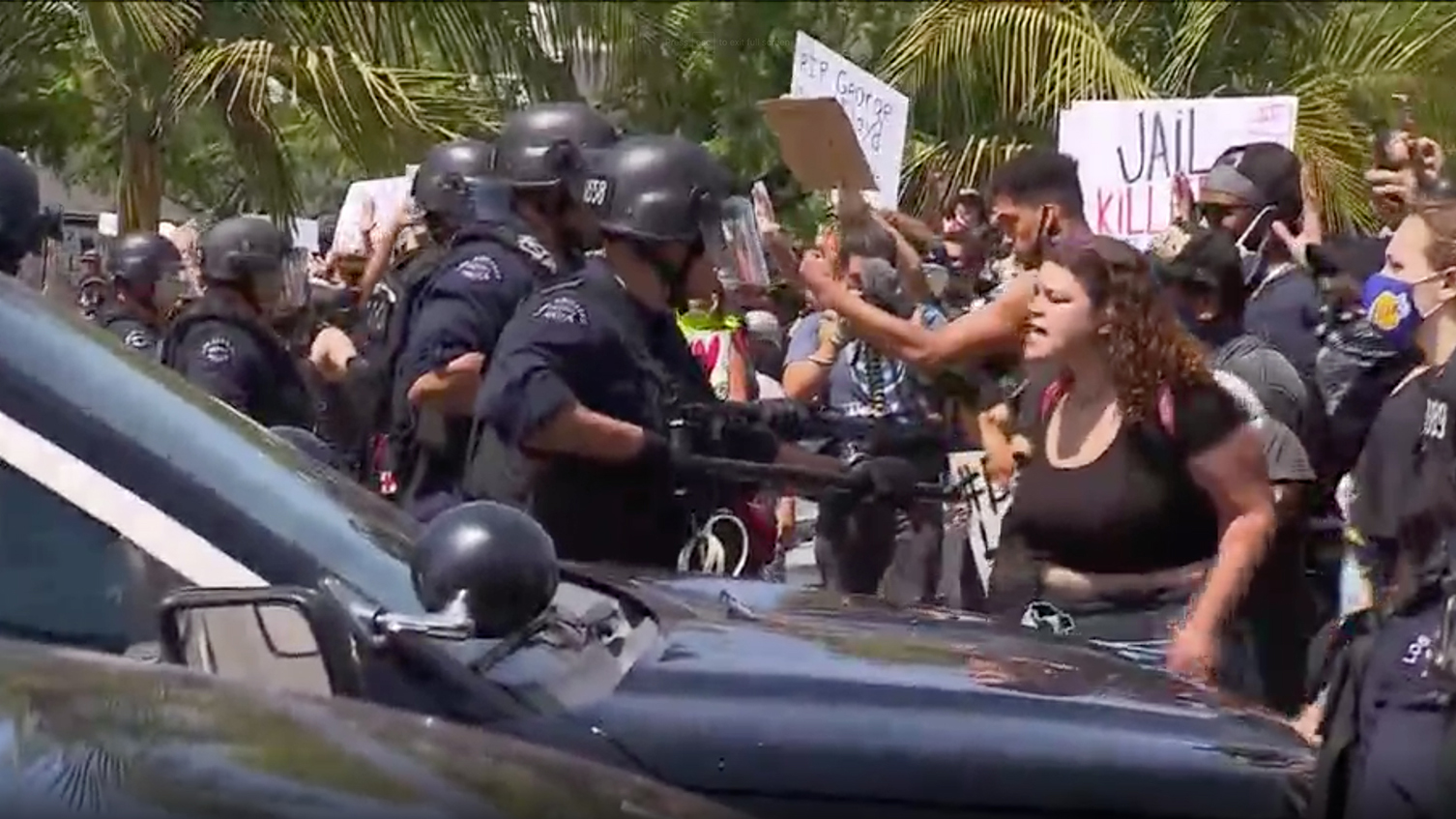 Protesters yell at police while rubber bullets are fired at the crowd in Los Angeles, on May 30.