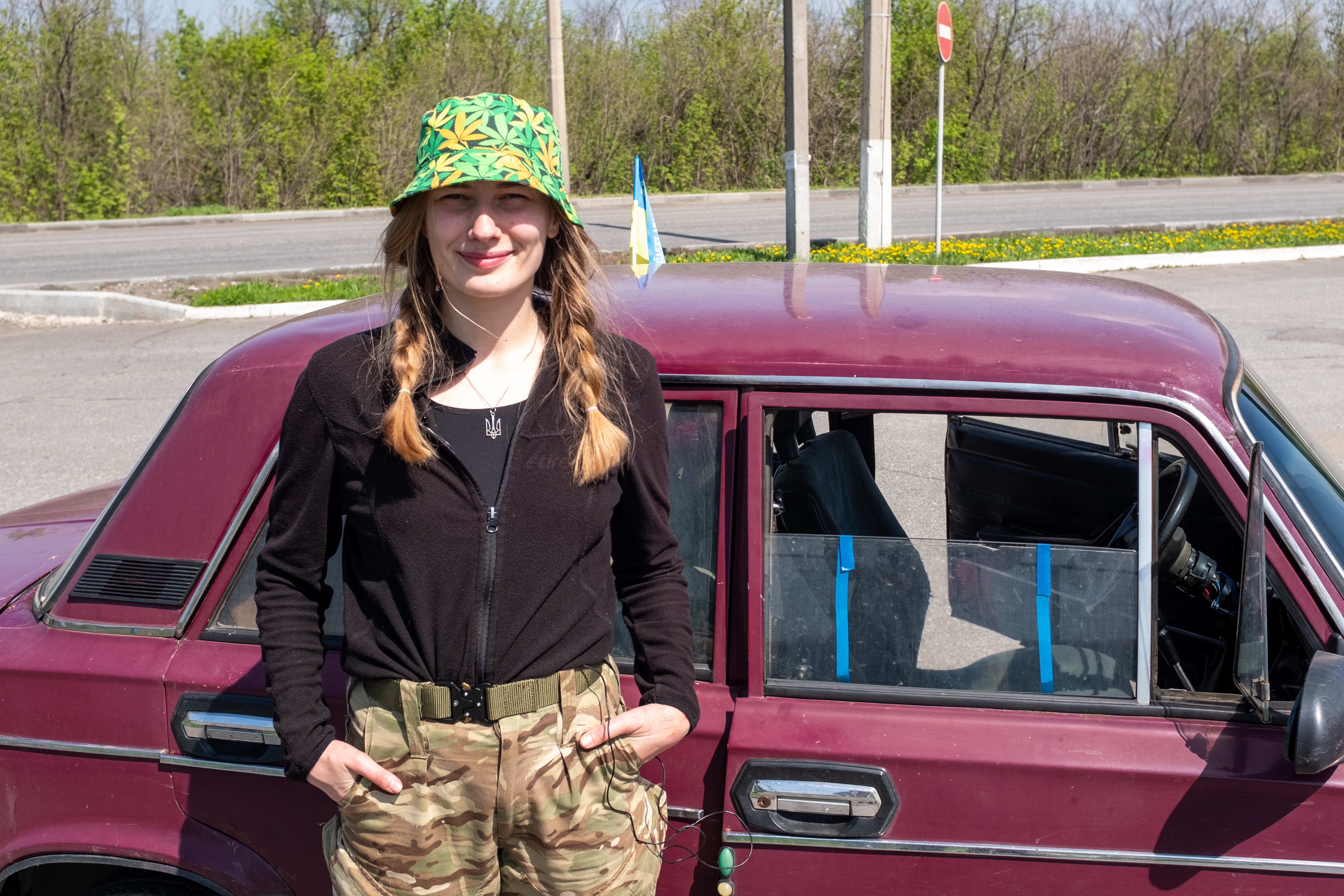 Maria Shtern, 21, stands in front of her car which she uses to deliver supplies to frontline towns in Ukraine, on Monday, April 25. 