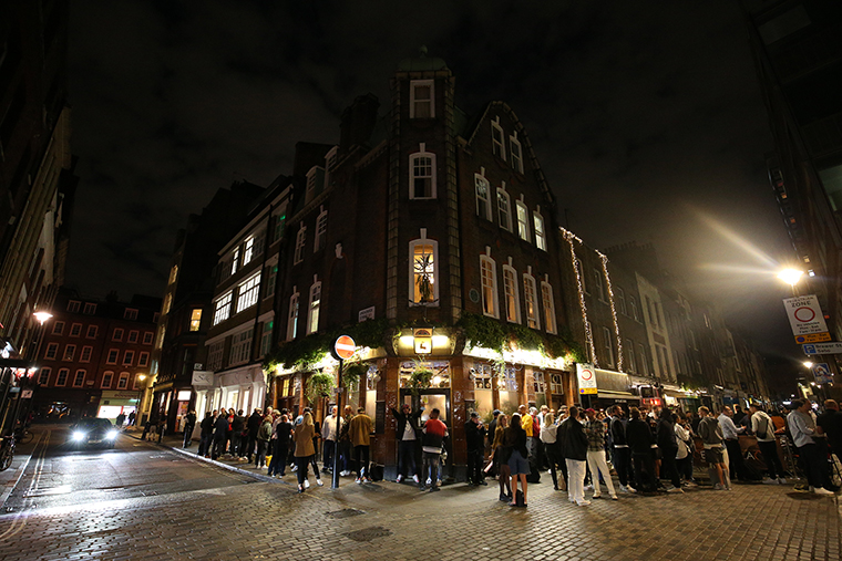 People gather outside a pub in Soho, London on September 10. 
