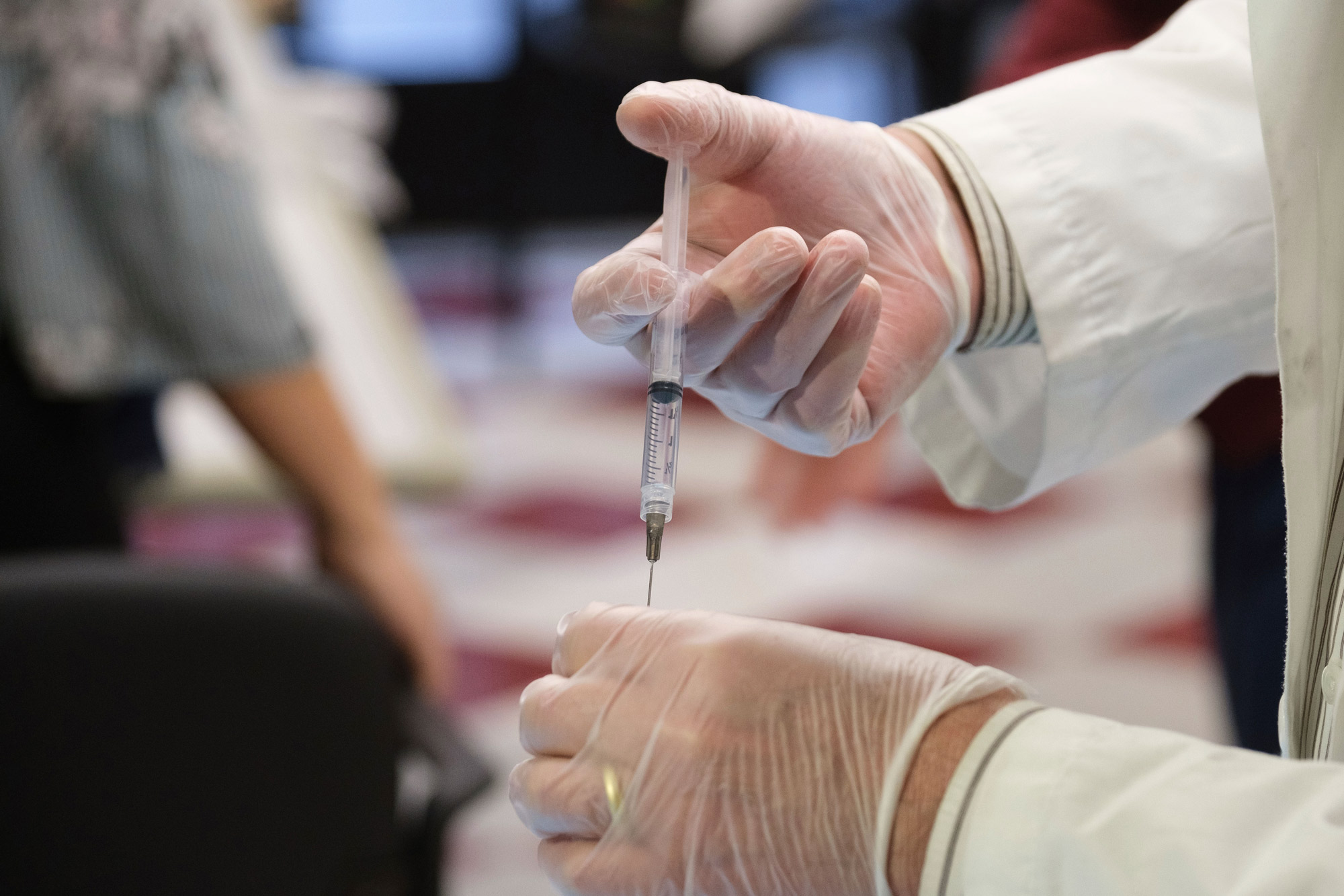 A shot of the COVID-19 vaccine is prepared for nursing home residents at Harlem Center for Nursing and Rehabilitation on January 15 in New York. 