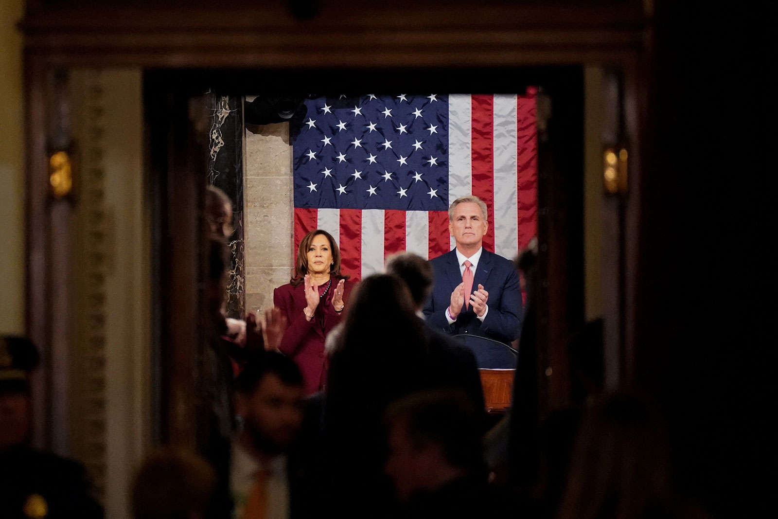 Vice President Kamala Harris and Speaker of the House Kevin McCarthy clap as people enter the House chamber ahead of Biden's speech.
