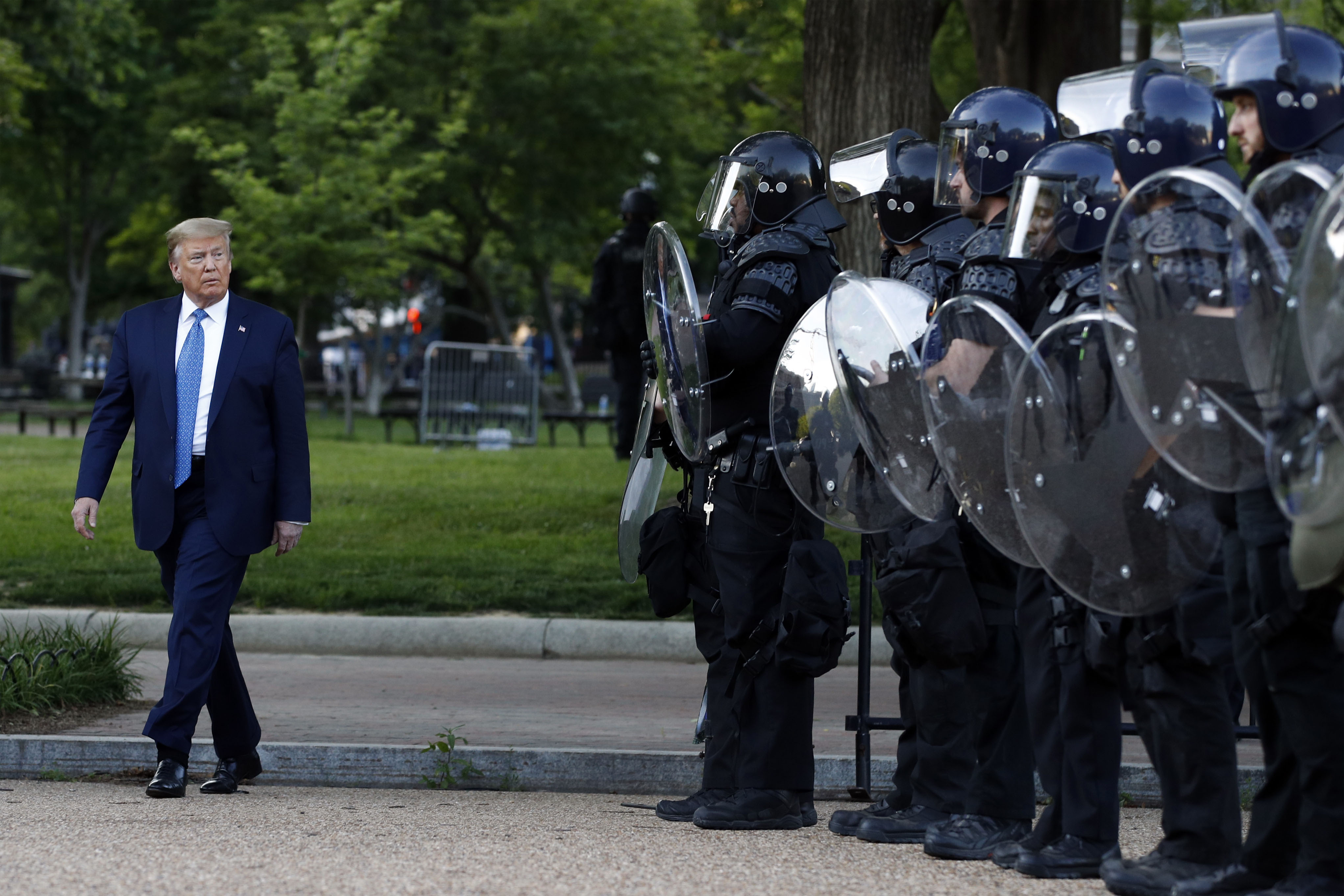 President Donald Trump walks past police officers in Washington's Lafayette Park on June 1.