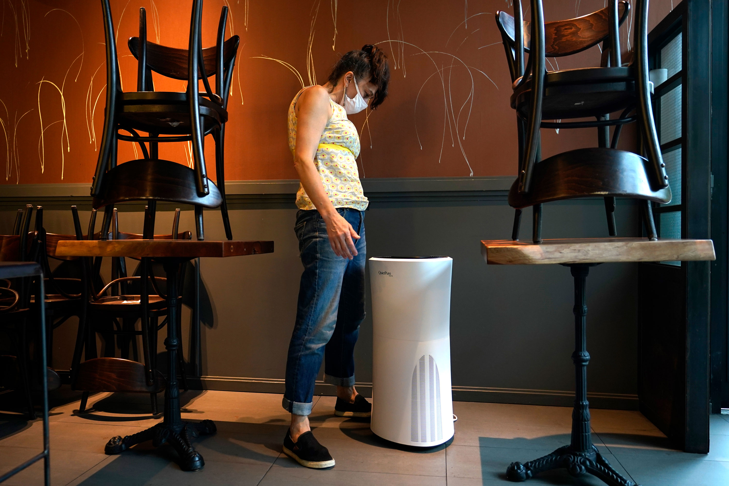 Samantha DiStefano, owner of Mama Fox, looks at an air purifier on September 29 in Brooklyn, New York. She'll need the air purifier when she opens the indoor portion of her restaurant and bar.