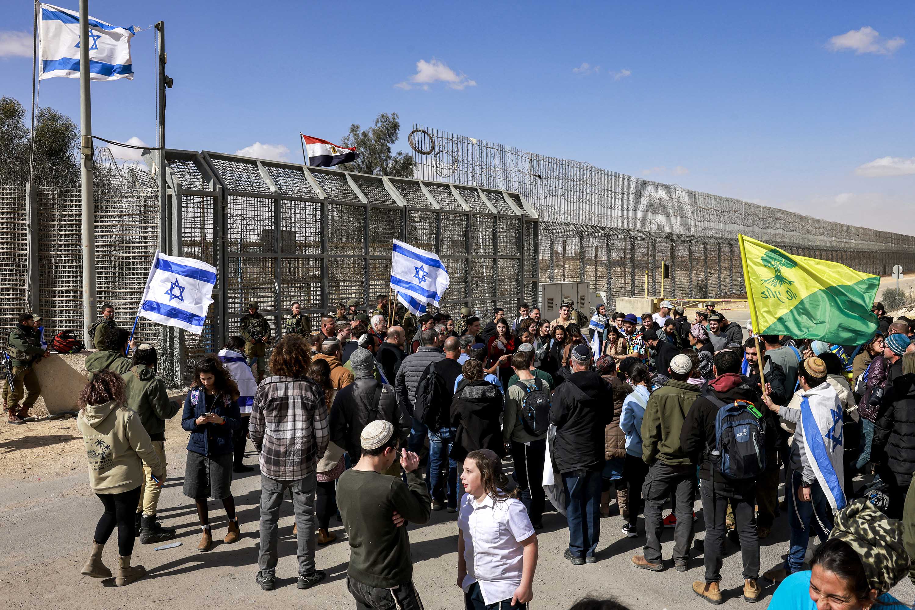 Demonstrators gather by the border fence with Egypt at the Nitzana border crossing in southern Israel as they attempt to block humanitarian aid trucks from entering into Israel on their way to Gaza, on January 30.