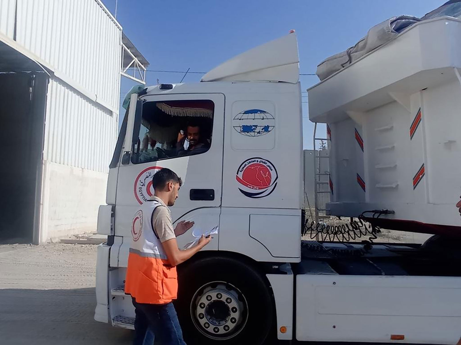 Palestinian Red Crescent teams receive trucks with humanitarian aid from the Egyptian Red Crescent at the Rafah crossing on November 1. 