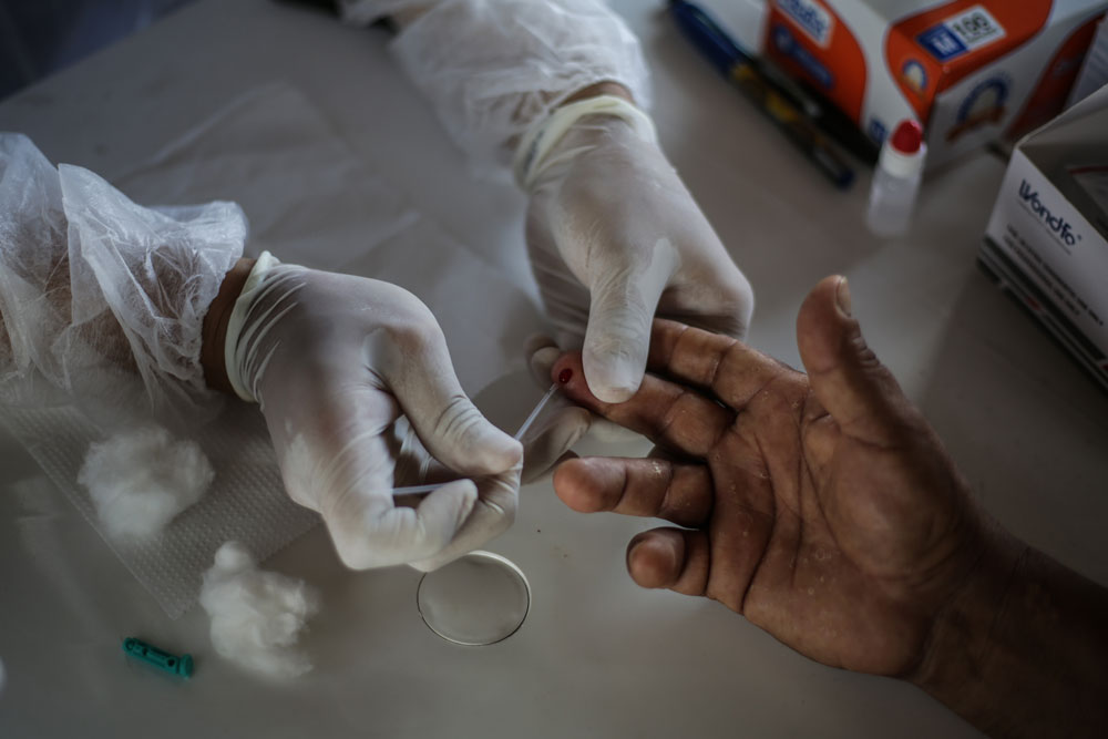 A nurse performs a coronavirus test at Parque das Tribos community on May 21 in Manaus, Brazil. 