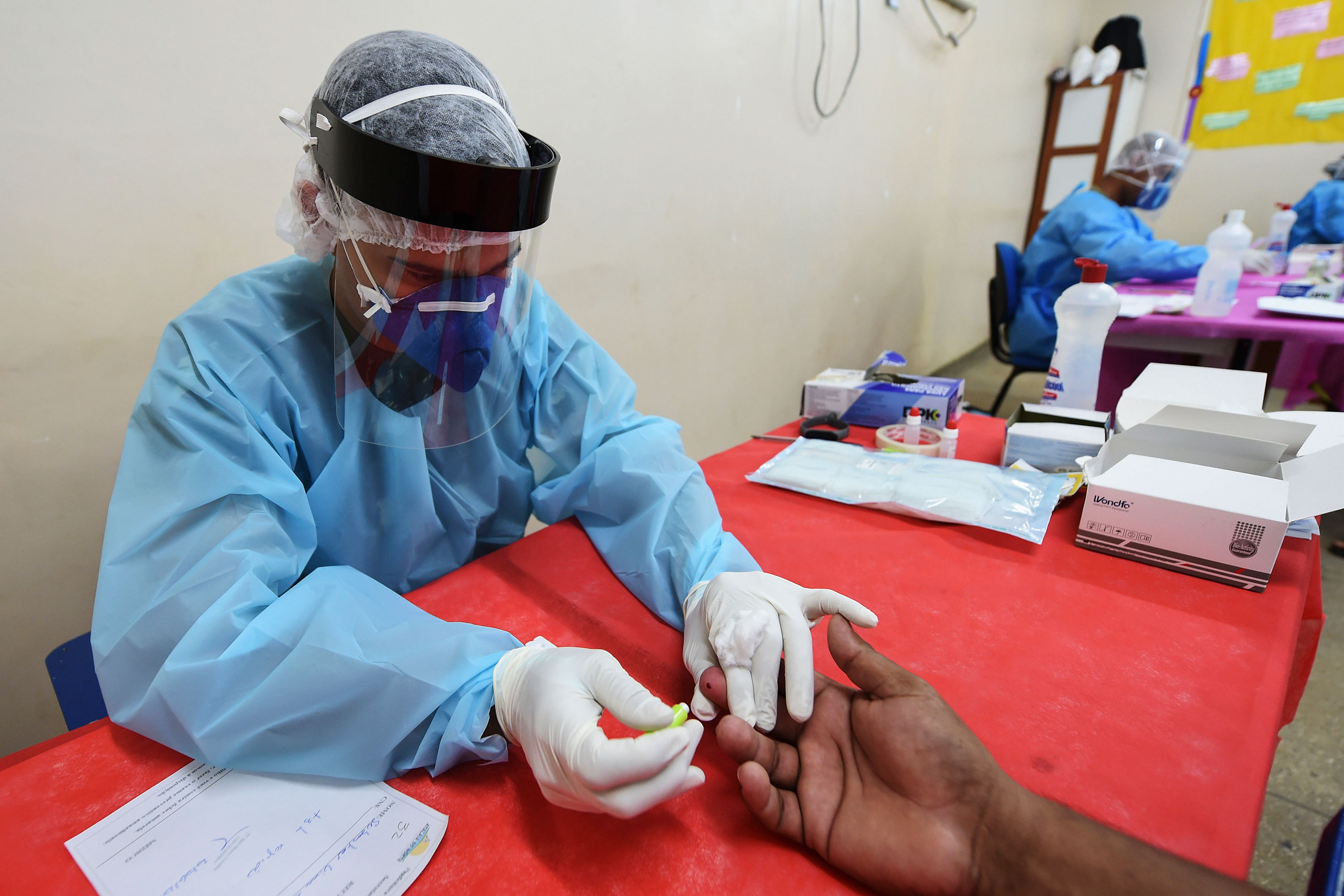 A Brazilian Armed Forces medical team member administers a coronavirus test on June 20 at a health post in Atalaia do Norte, Brazil.