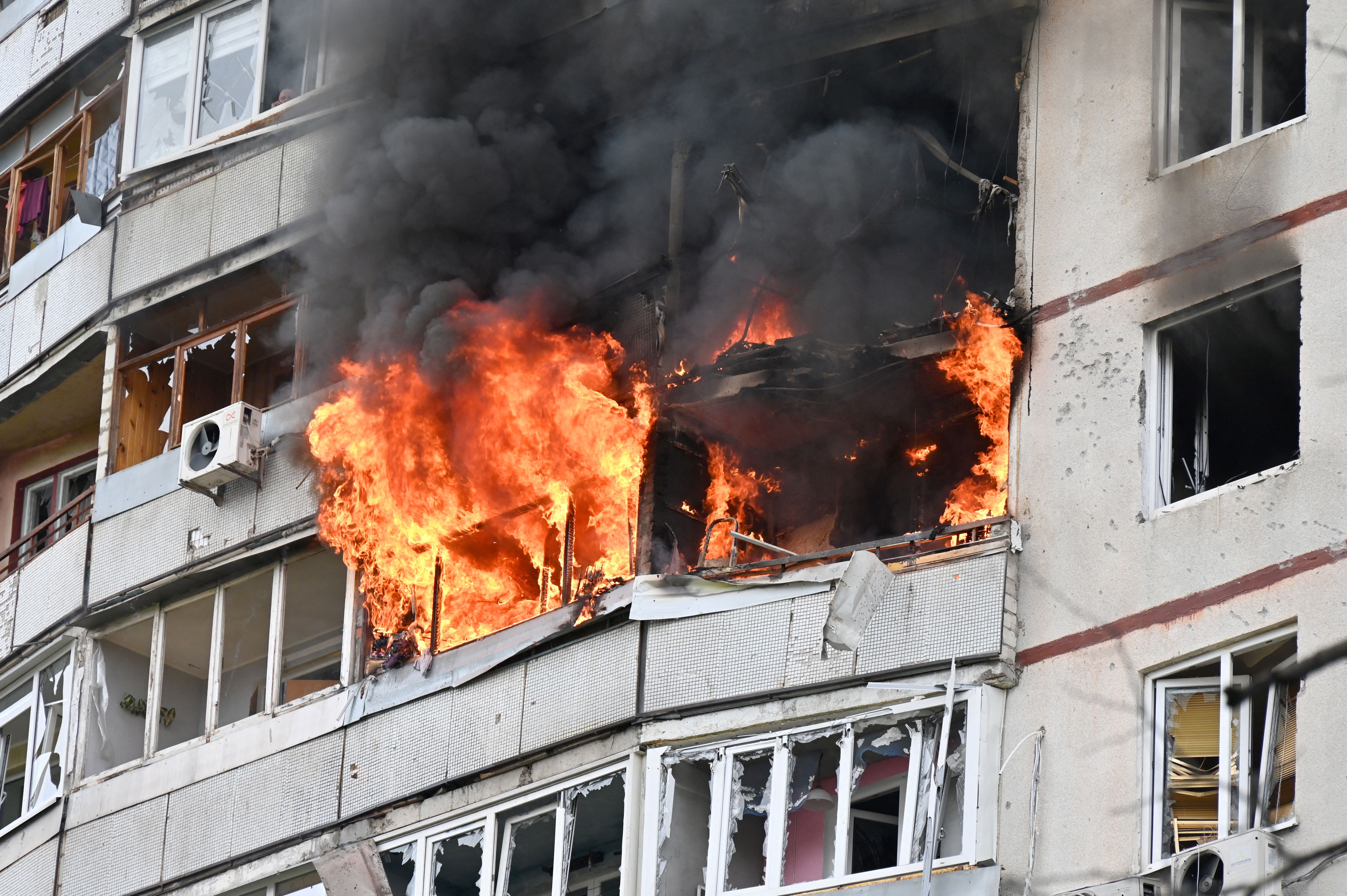 Flames come out of an apartement in a residential building of the northern outskirts of Kharkiv following shelling on April 22.