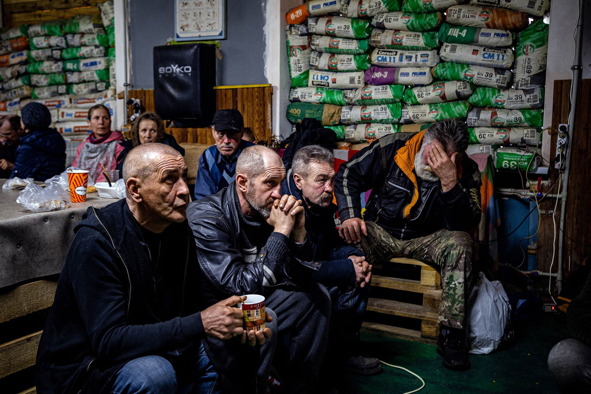 Ukrainians watch a movie on TV at a humanitarian aid centre in Bakhmut, Ukraine, on February 27.