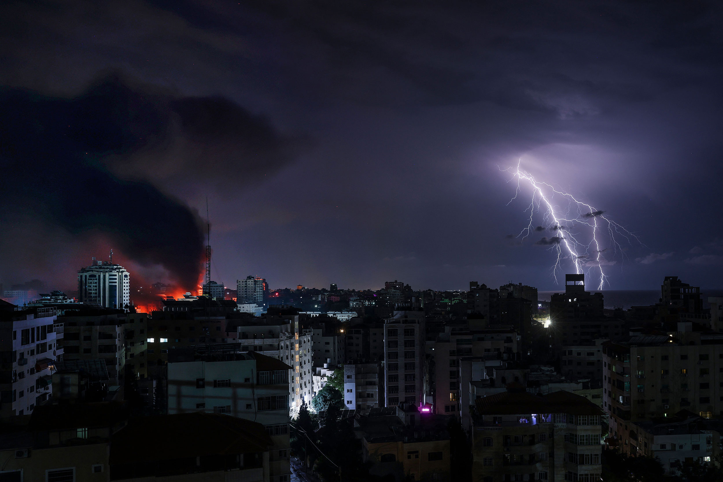 Lightning strikes over Gaza City following an Israeli bombardment on October 9, 2023.