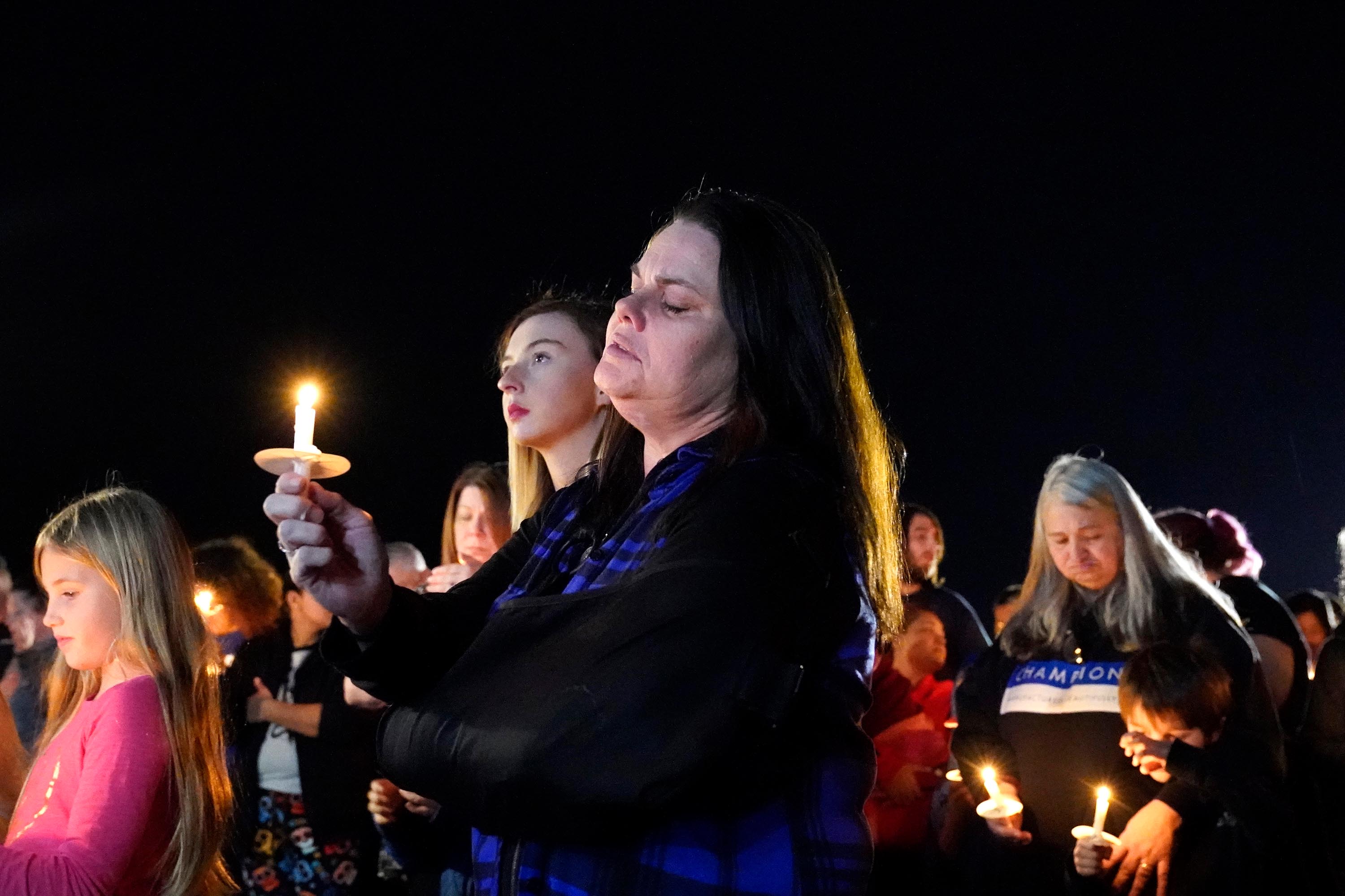 People participate in a candlelight vigil in the aftermath of tornadoes that tore through the region several days earlier, in Mayfield, Kentucky, late Tuesday, December 14.