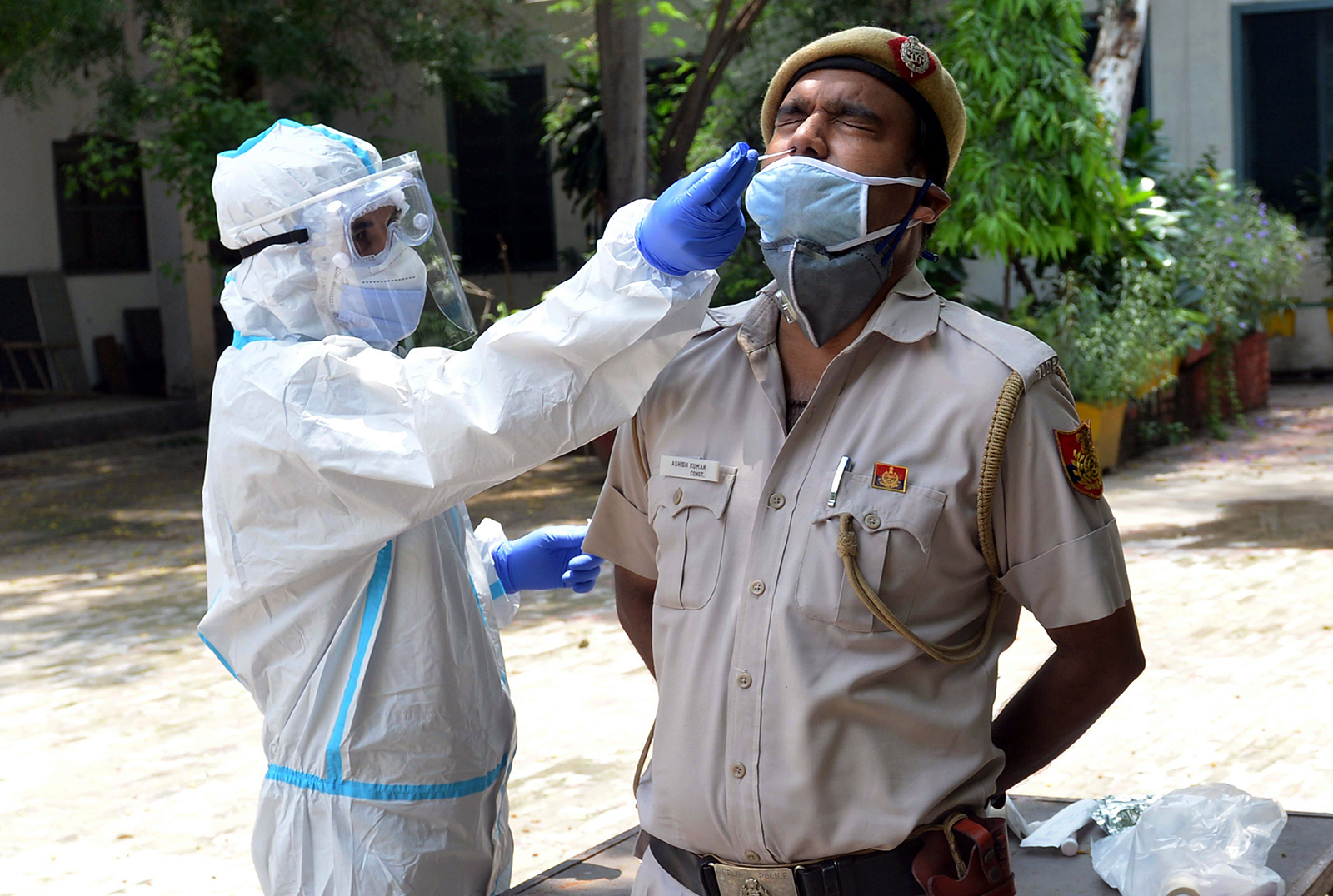 A health worker collects a sample for Covid-19 testing from a police officer in New Delhi, India on August 2.