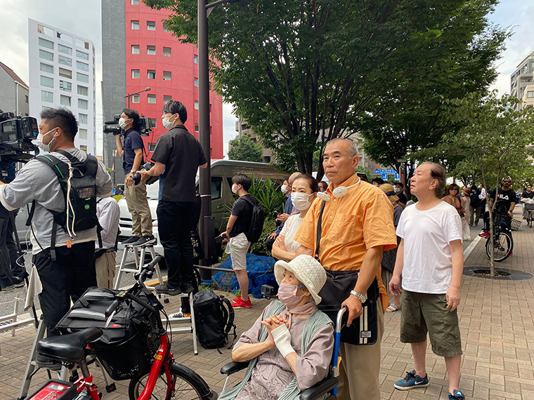 People gather near the Abe family residence in Tokyo on Saturday.
