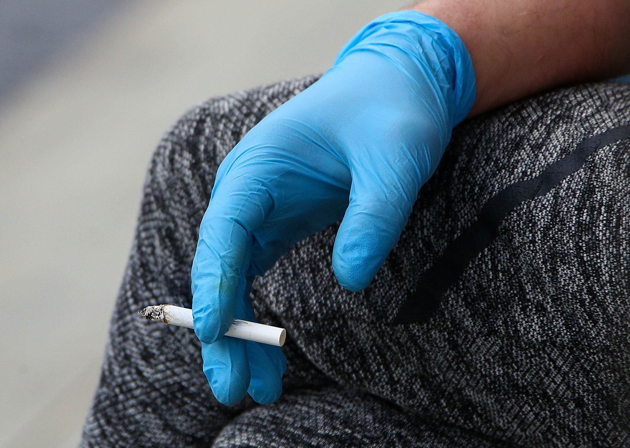 A person holds a cigarette in Moscow on May 12.