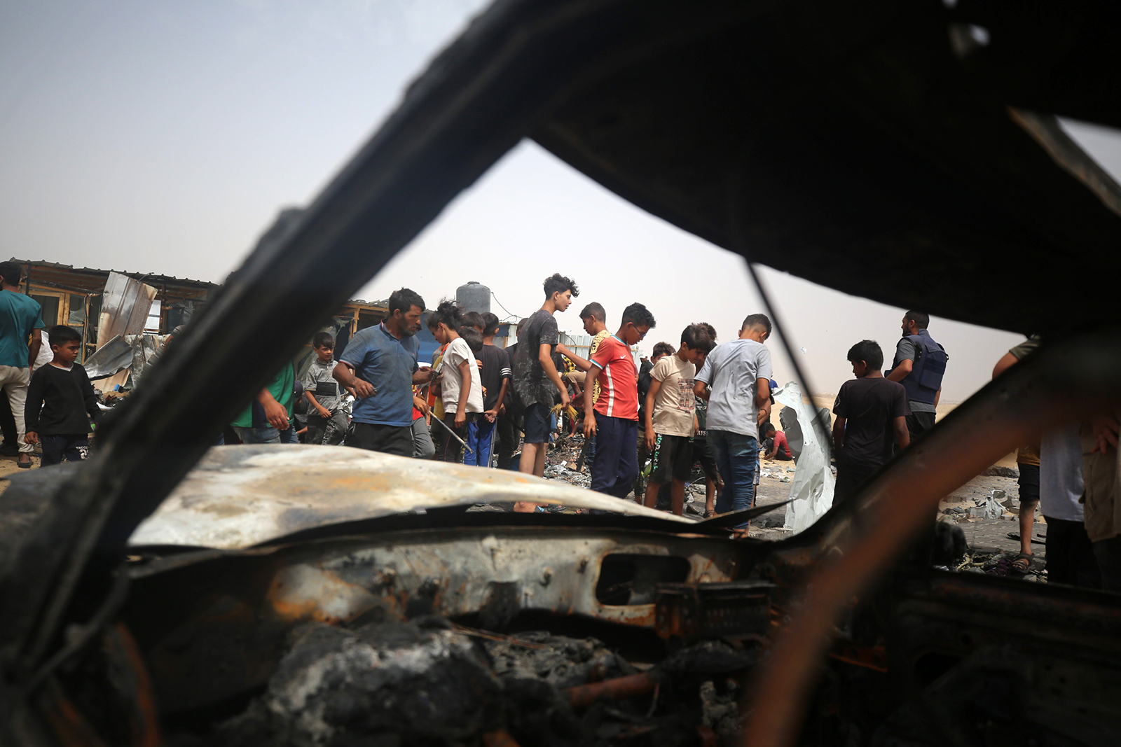 Palestinians are gathering at the site of an Israeli strike on a camp for internally displaced people in Rafah, on May 27.