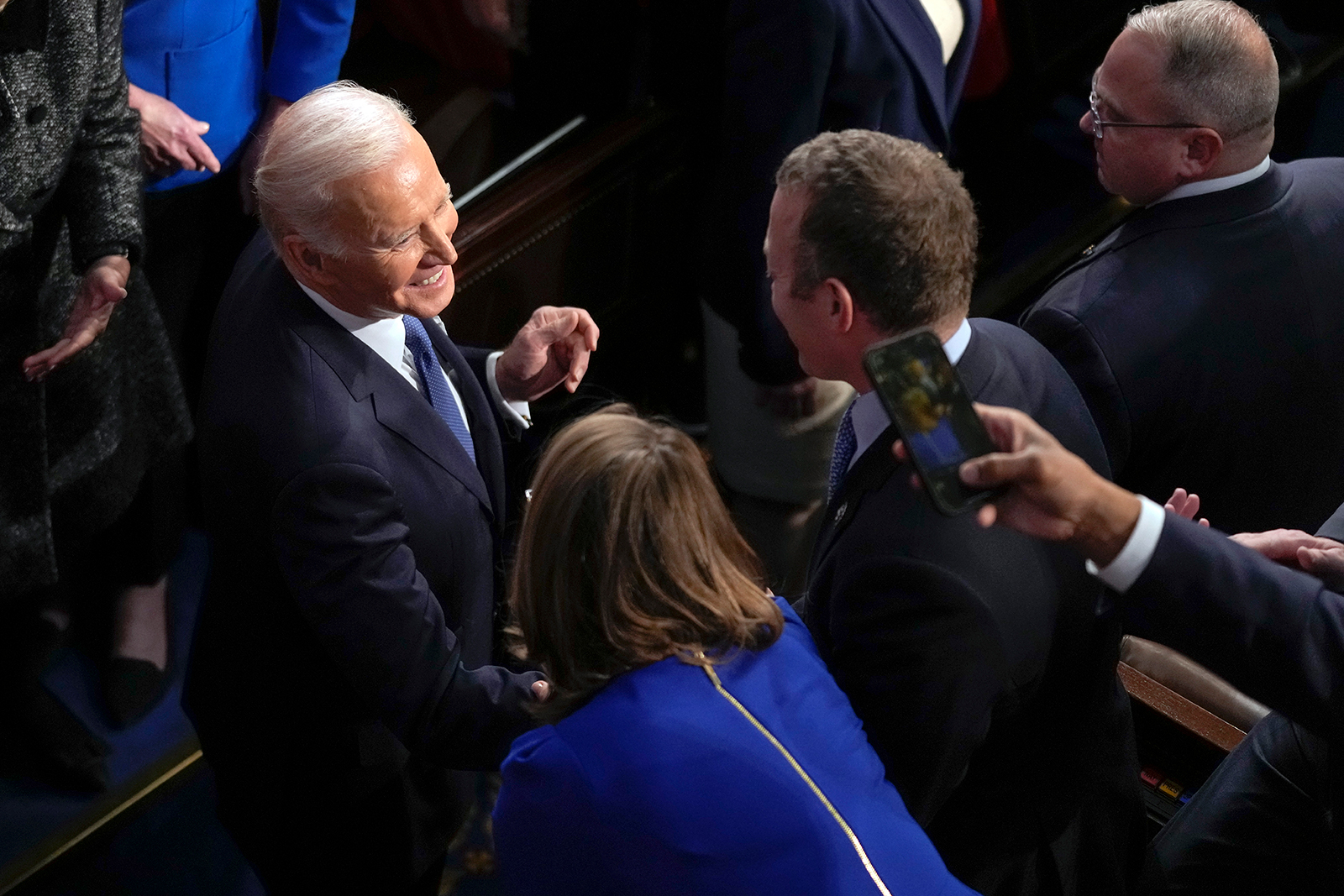 President Joe Biden greets people as he arrives in the House chamber to deliver the State of the Union address.