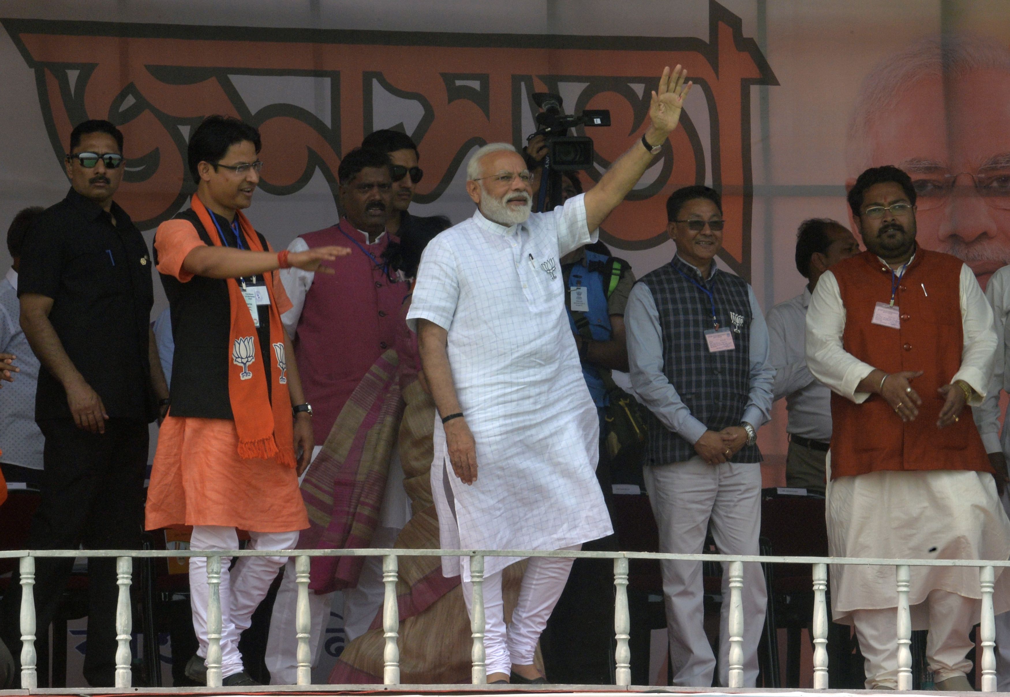 Indian Prime Minister Narendra Modi waves to supporters during a campaign rally in Siliguri on April 3, 2019. 