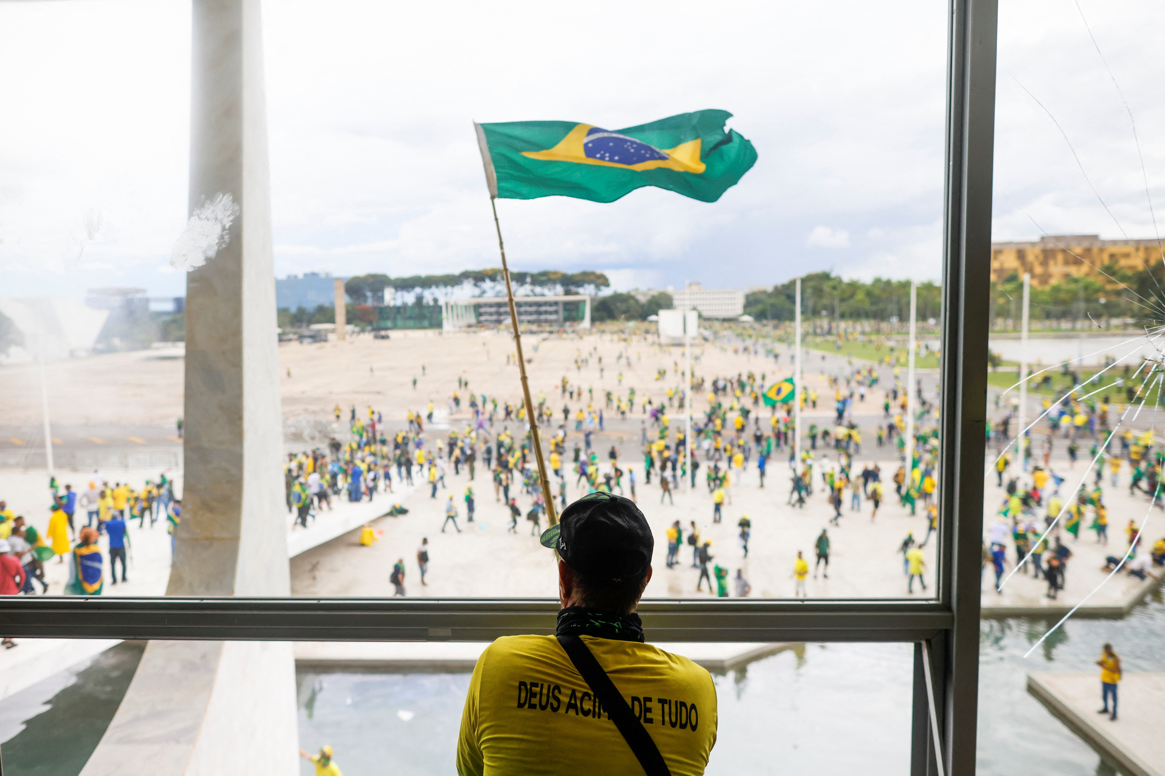 A man waves Brazil's flag as supporters of Brazil's former President Jair Bolsonaro demonstrate against President Luiz Inácio Lula da Silva, outside Brazil’s National Congress in Brasília, Brazil on Sunday.