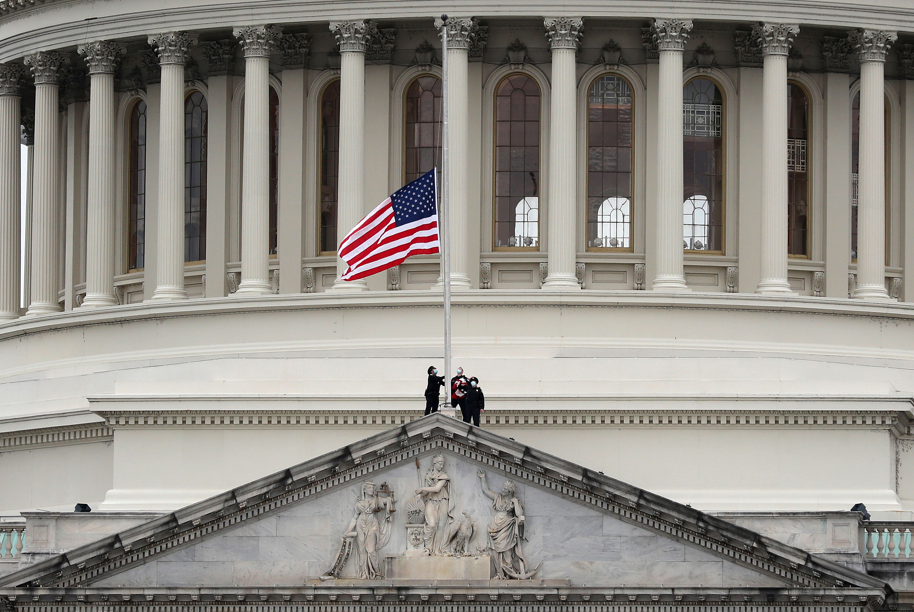 The US flag at the Capitol is lowered to half-staff on January 8 following the death of Capitol Police Officer Brian Sicknick.