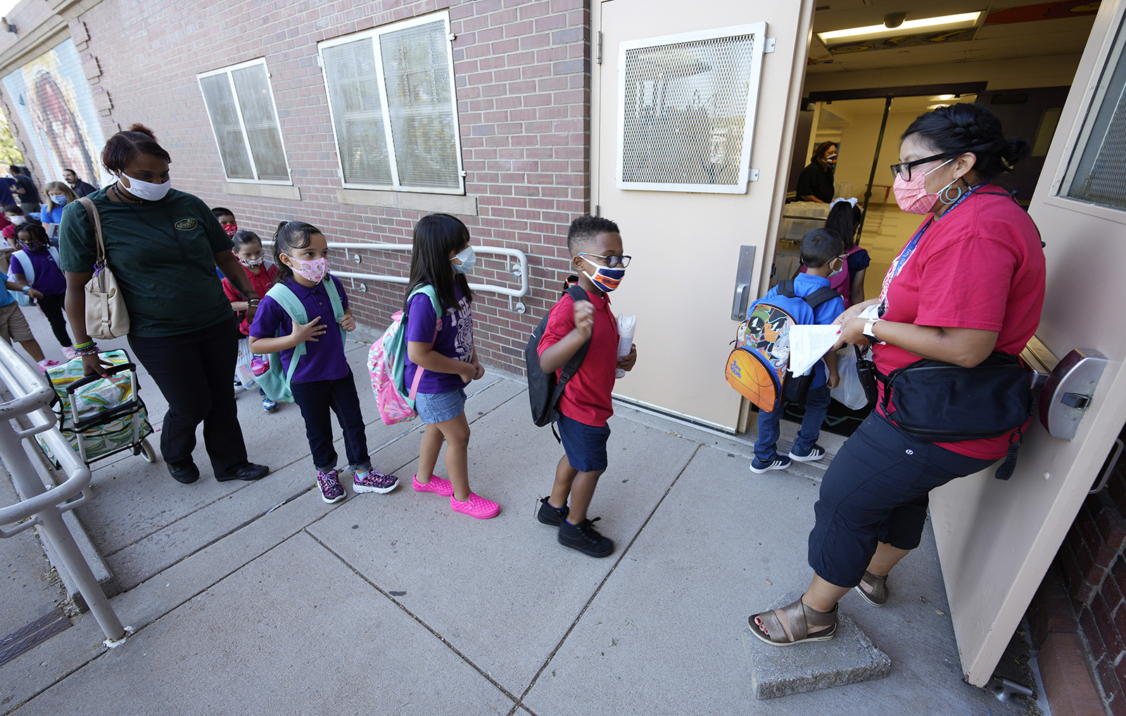 Students in masks start their first day of in-class learning since the start of the pandemic at Garden Place Elementary School on Monday, Aug. 23, 2021, in north Denver. 