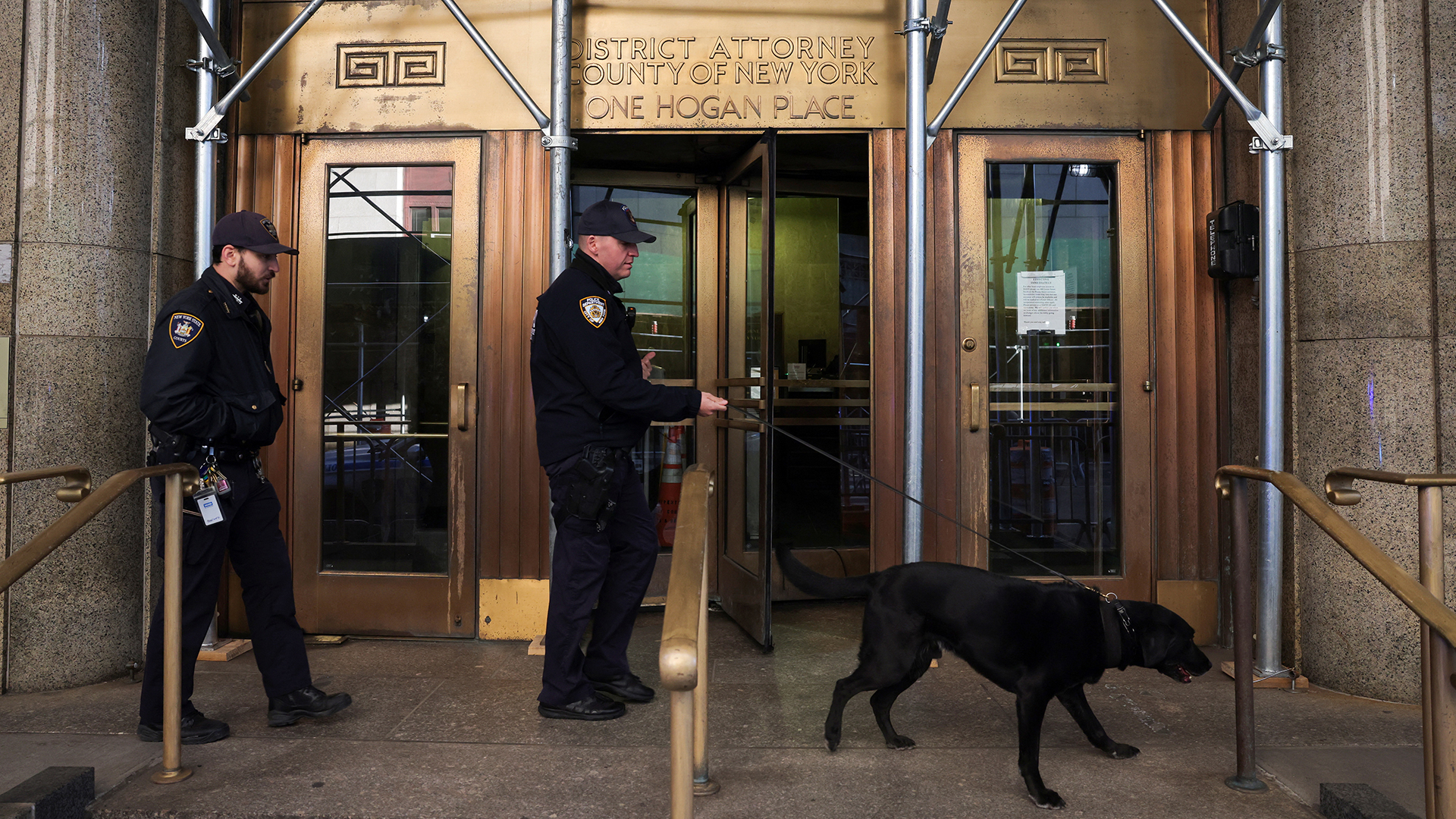 Officers from the New York City Police Department Canine Unit search around the District Attorney's Office in New York City on March 29.
