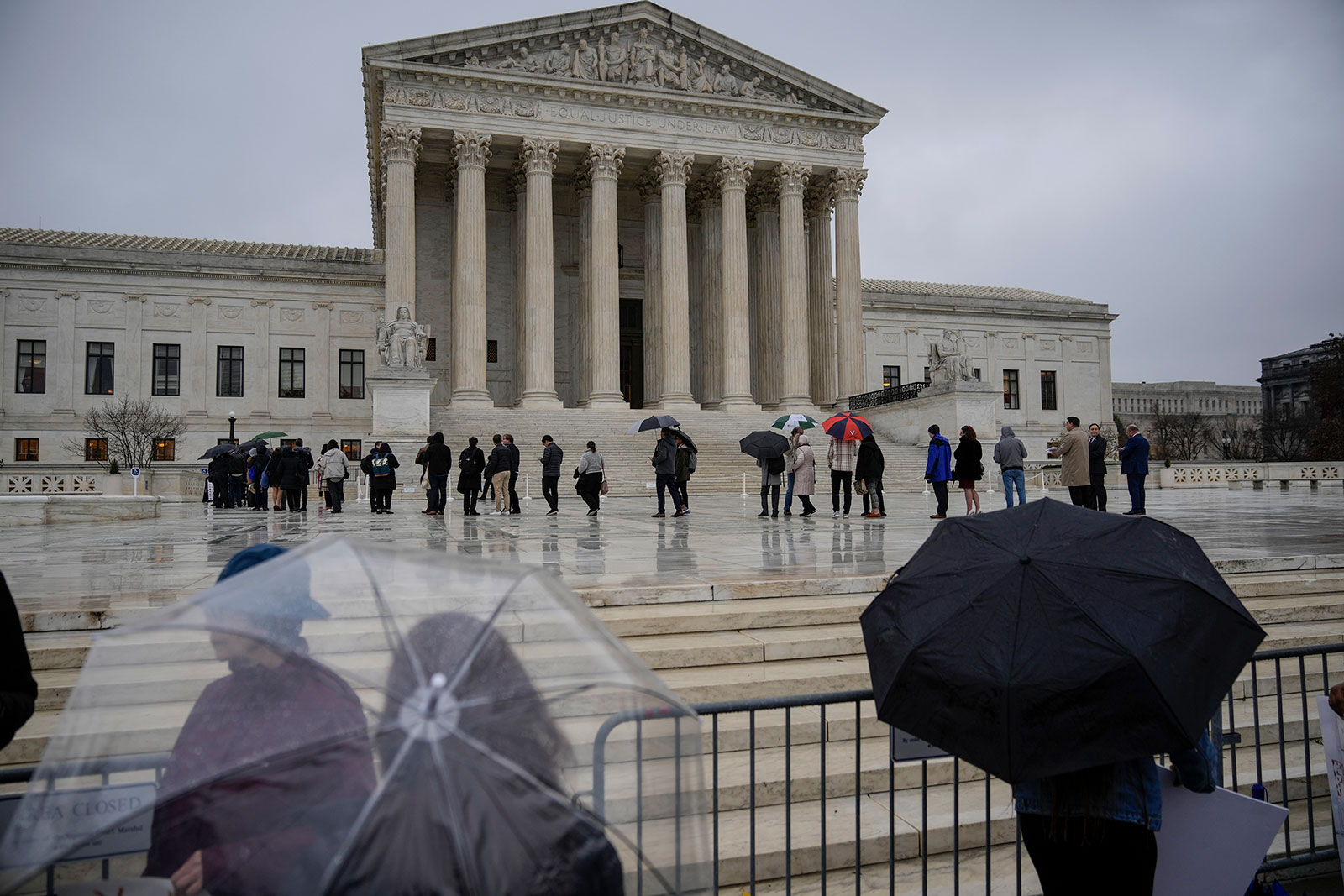 People wait in line outside the US Supreme Court to hear oral arguments in the Moore v. Harper case on December 7.