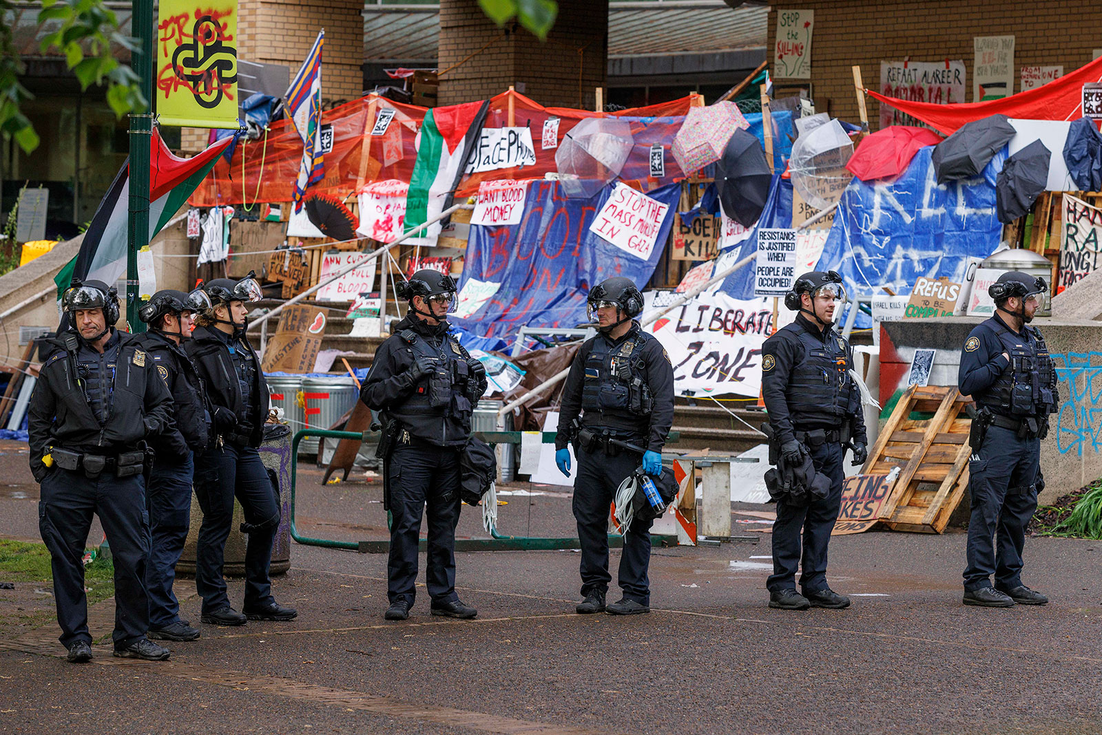 Portland police officers standby on the campus of Portland State University in Portland on Thursday.