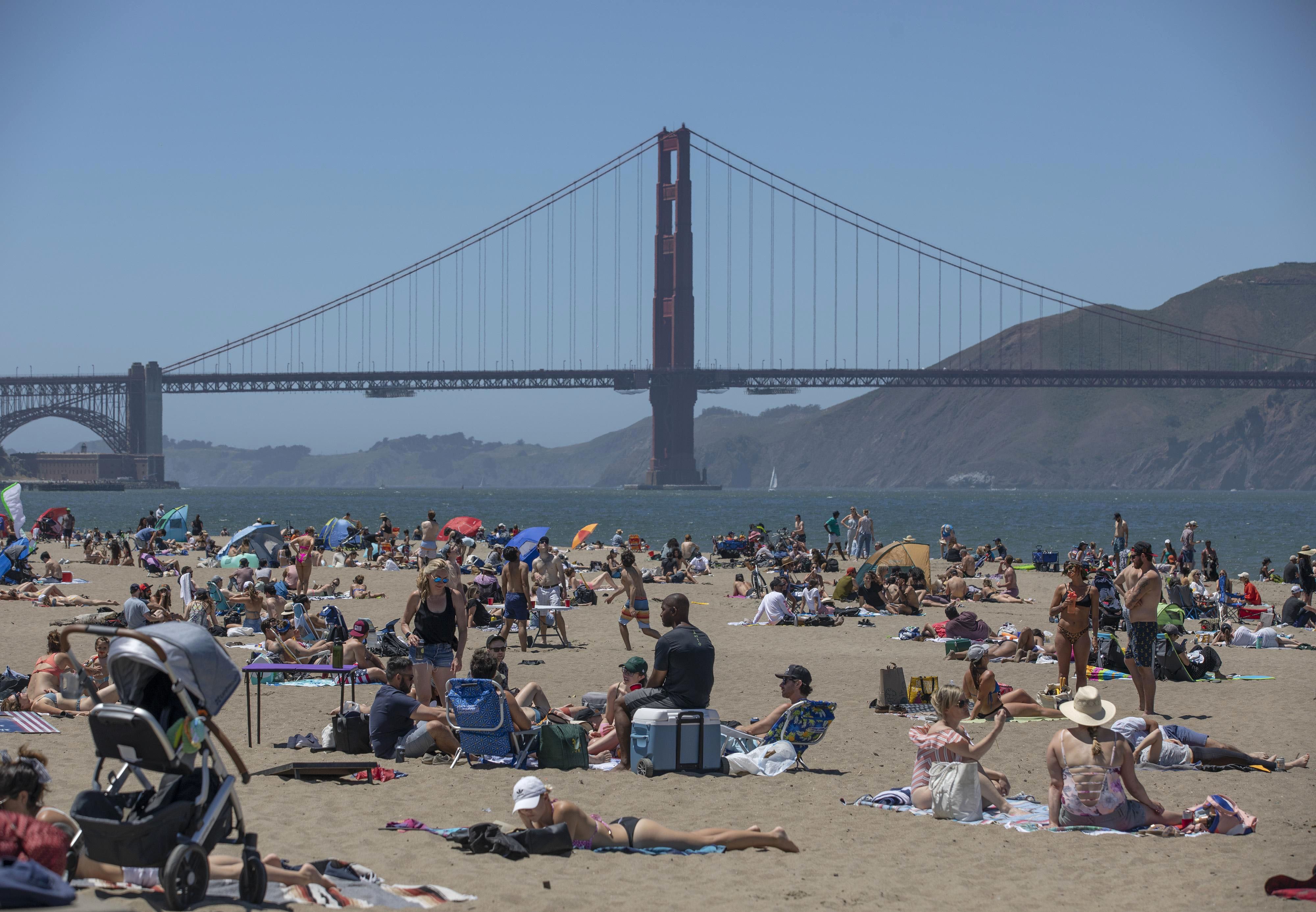 People visit a beach near the Golden Gate Bridge in San Francisco on May 25.