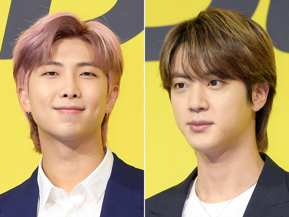 BTS members RM (left) and Jin (right) are seen in this split file photo from the K-pop group's press conference for the release of "Butter" in Seoul on May 21, 2021