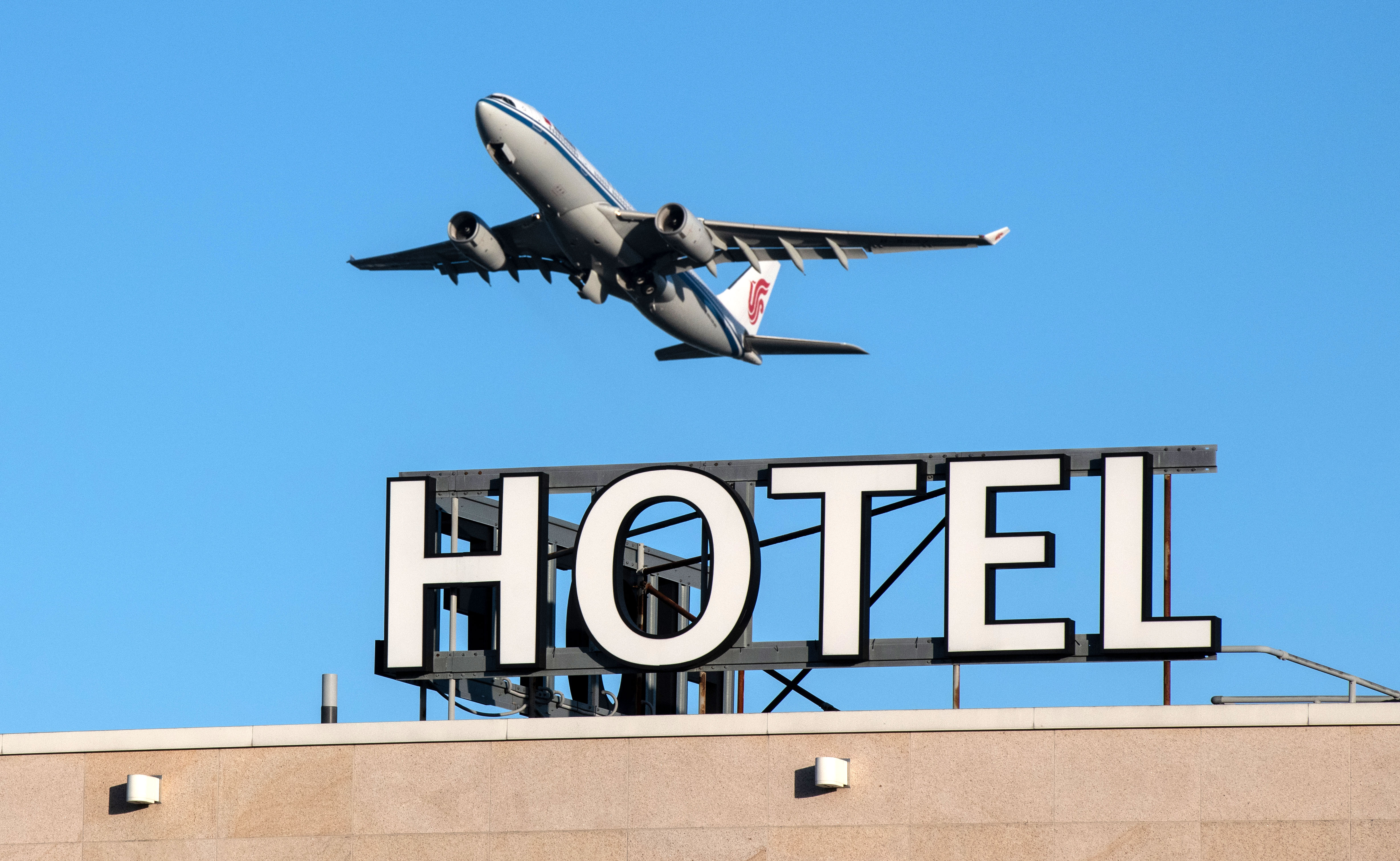 An airplane passes over a hotel as it takes off from Heathrow Airport in London on January 25.