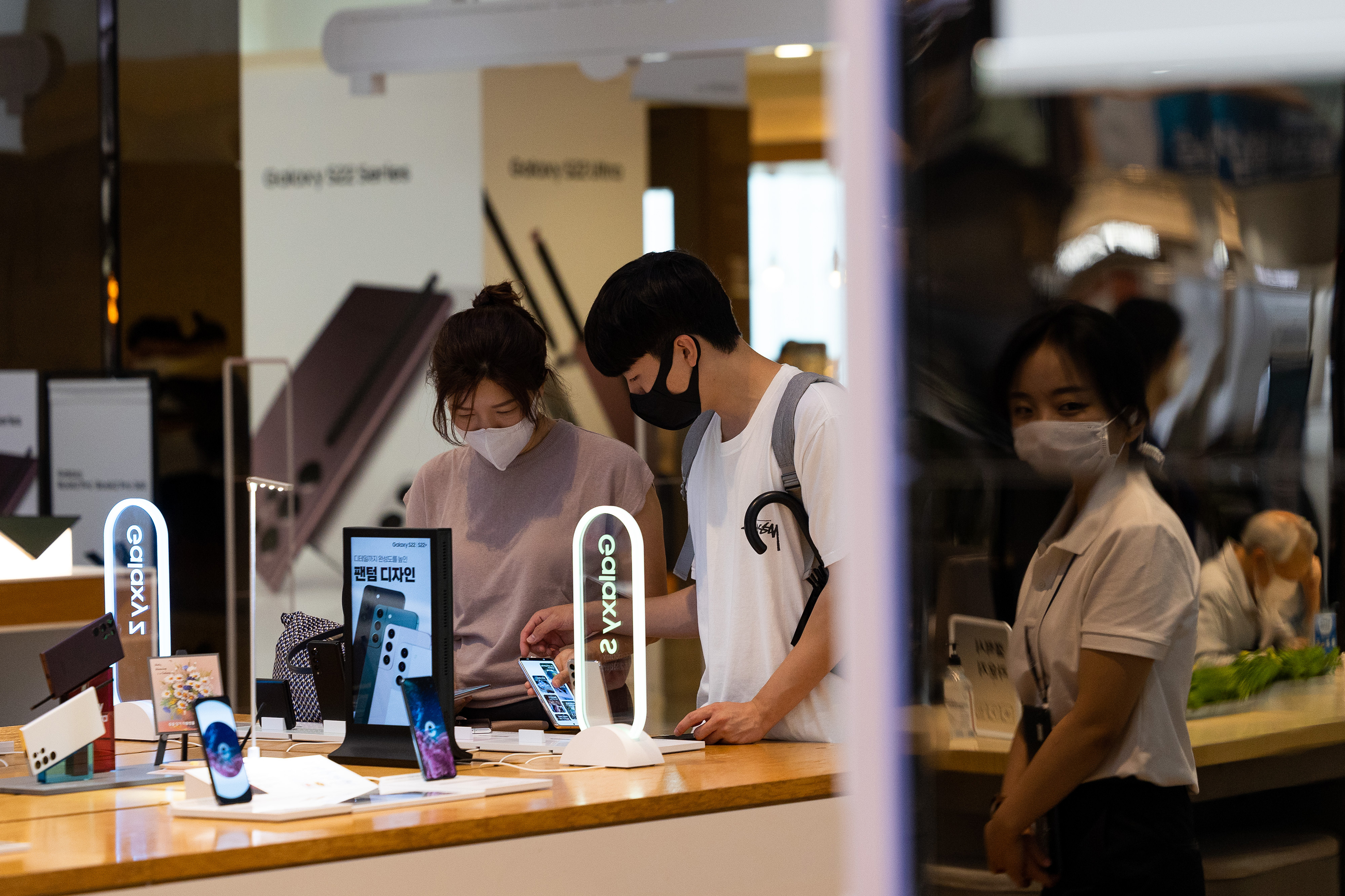 Customers try out Samsung Galaxy smartphones at the store in Seoul, South Korea, on July 5.