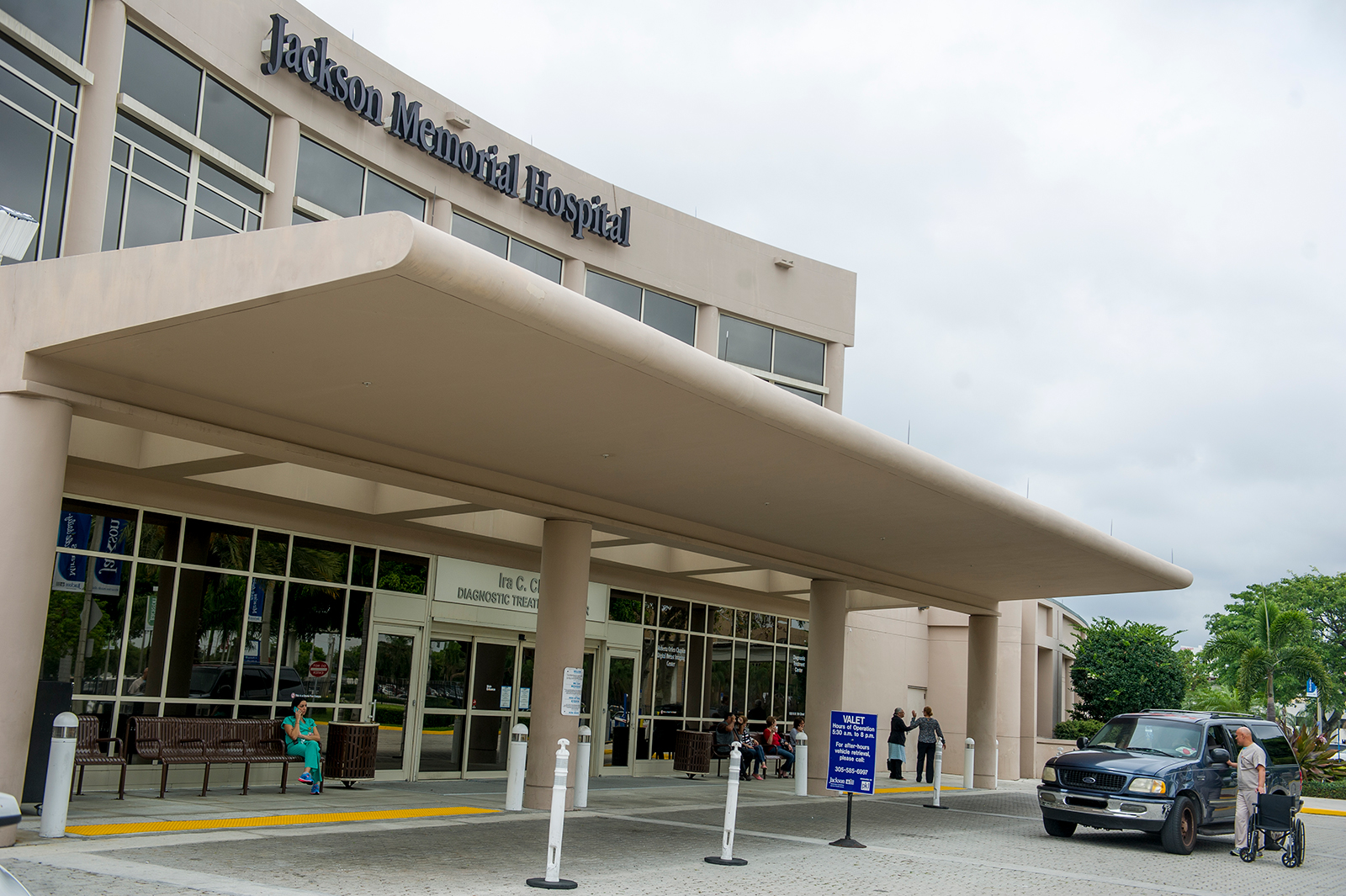 Patients and medical professionals enter and exit the Jackson Memorial Hospital in Miami on May 16, 2014. 