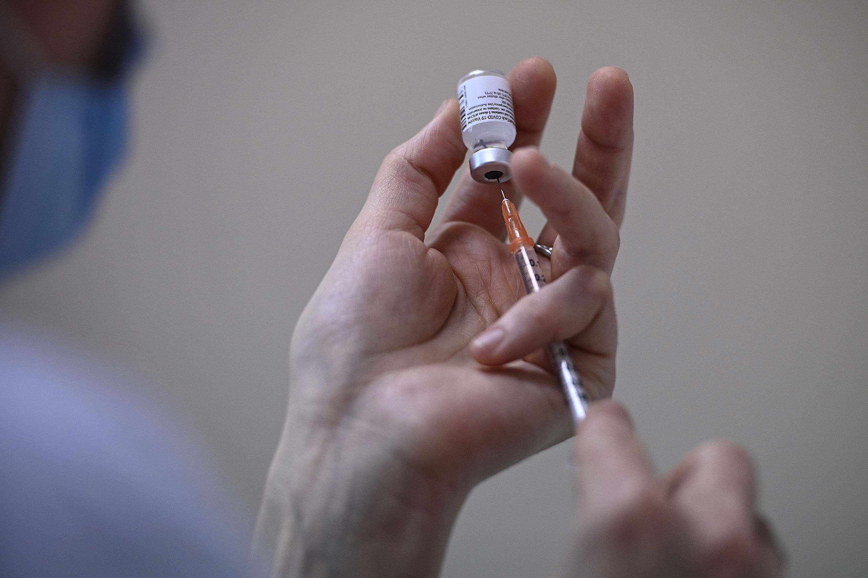 A nurse fills a syringe with a vial of the Pfizer BioNTech vaccine at the Pasteur Institute, in Paris, on January 21.