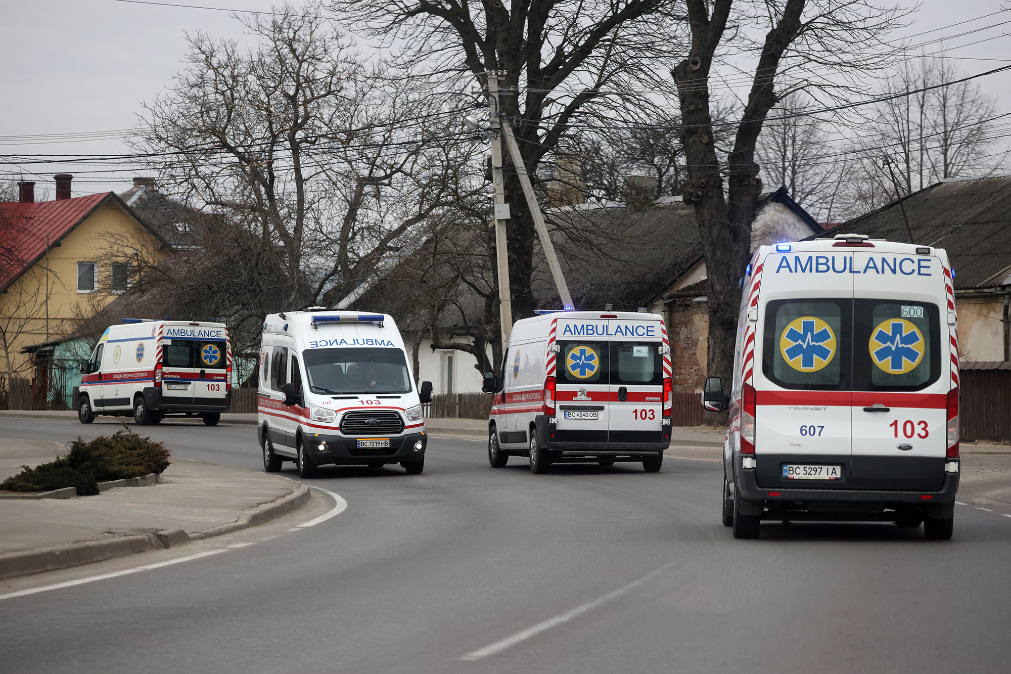 Ambulances are seen traveling to and from the Yavoriv military facility on March 13 in Novoiavorivsk, Ukraine. 