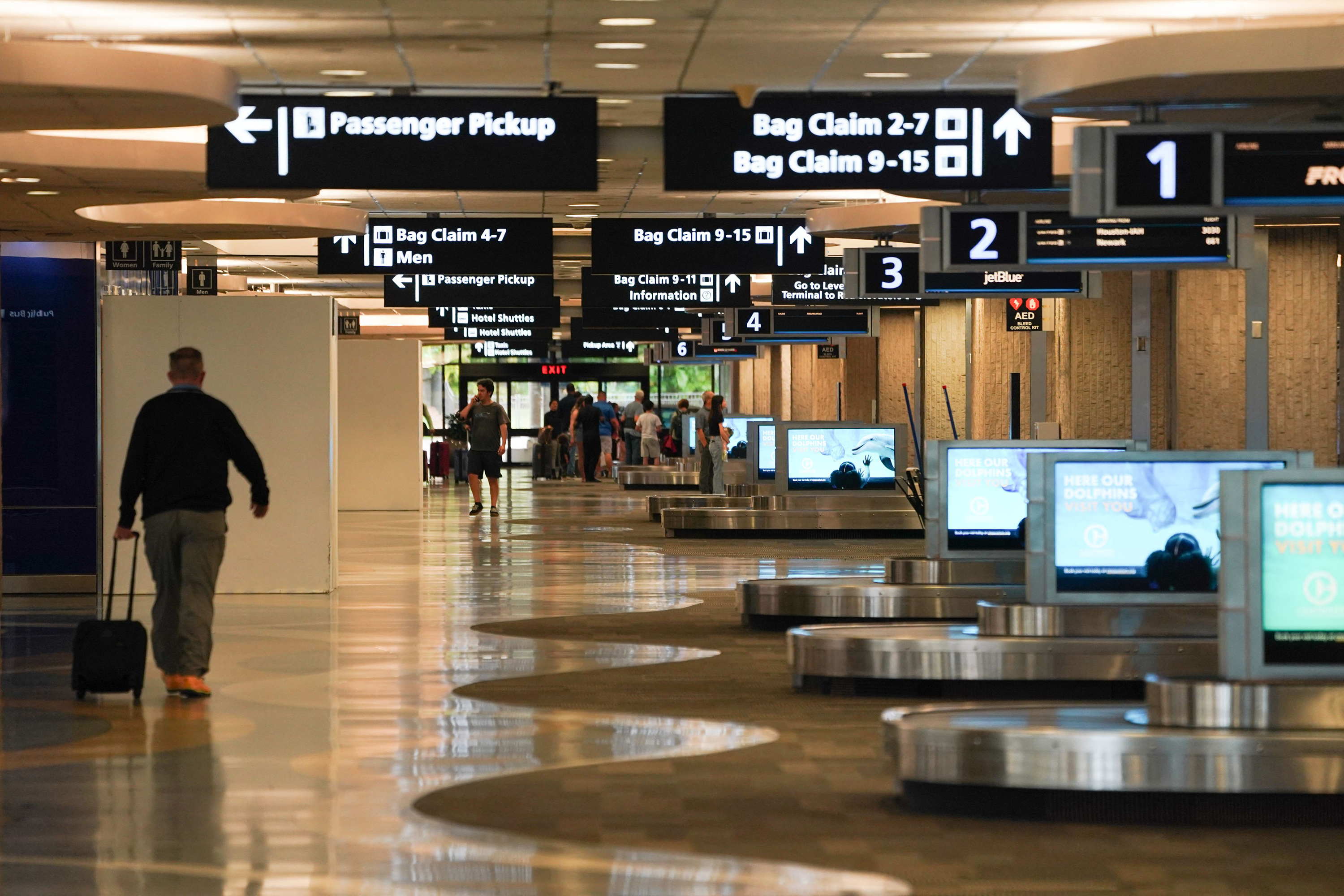 A man walks through the baggage claim area at Tampa International Airport before the airport is due to close at 5pm ET ahead of Hurricane Ian on Tuesday.