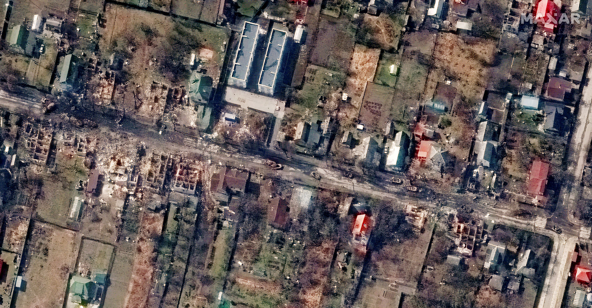 A satellite image shows destroyed homes and armored vehicles along Vokzalna Street, in Bucha, Ukraine, on March 31.