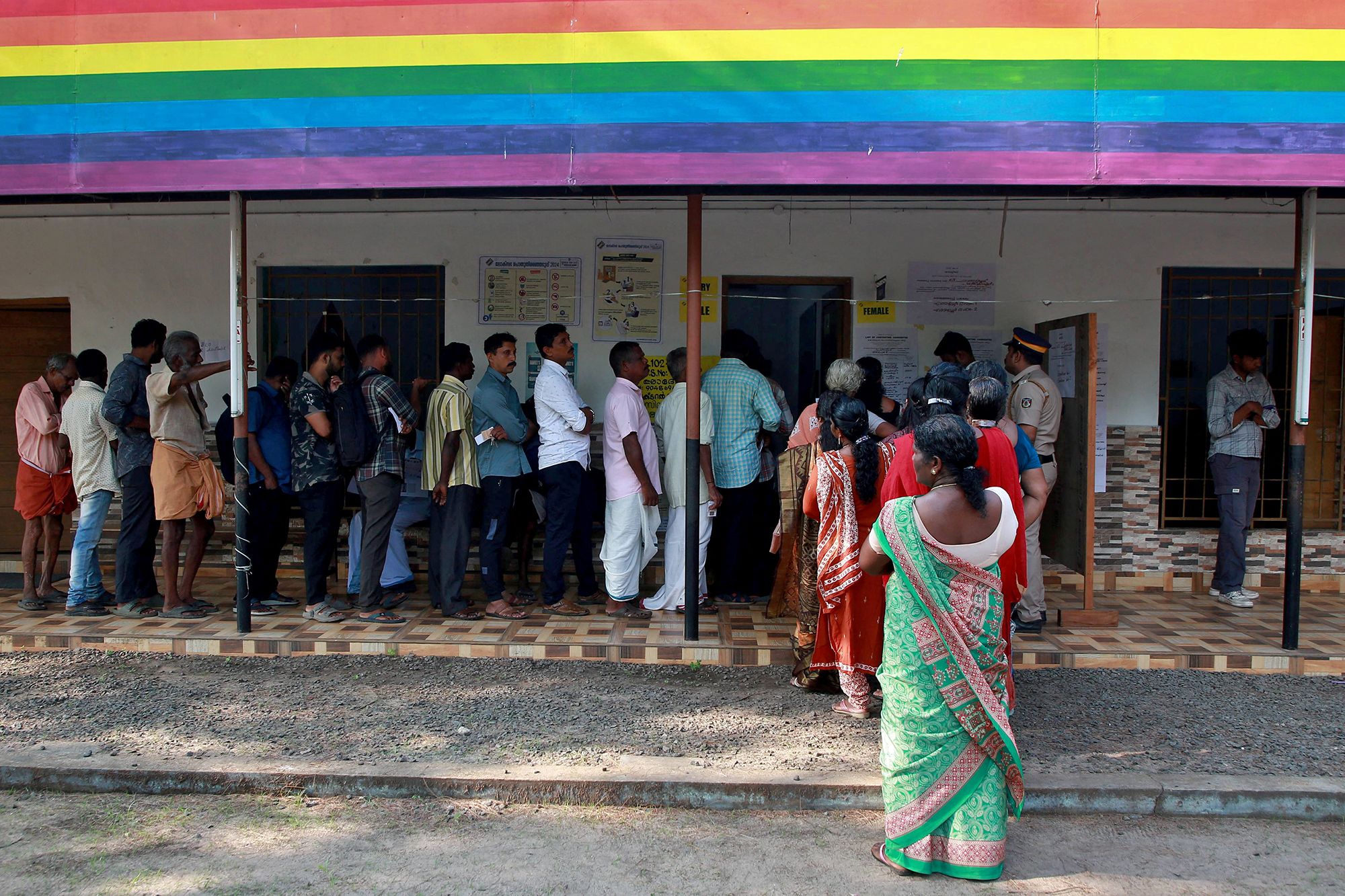 People wait in lines to cast their votes at a polling station during the second phase of general election in Ezhupunna village in the southern state of Kerala, India, on April 26.